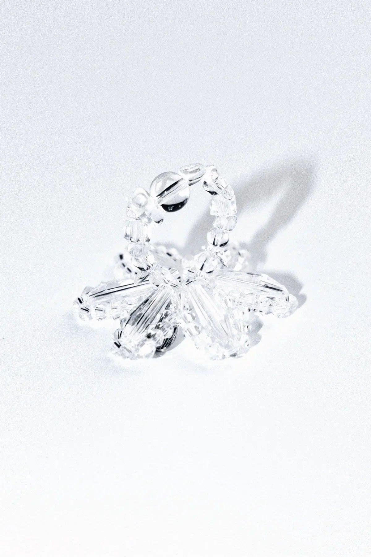 Transparent crystal beaded ring with clear faceted beads on white background