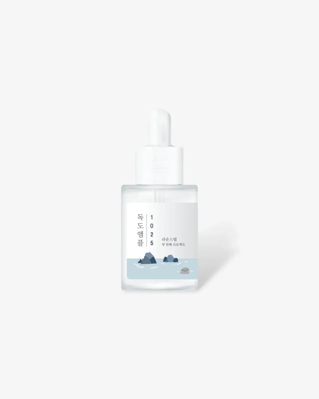 Clear glass dropper bottle with Korean text and ocean rock illustration on white background