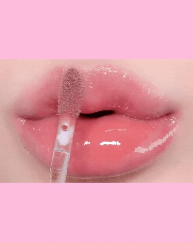 Glossy pink lips with a clear 3D volumizing lip gloss applicator enhancing shine and moisture