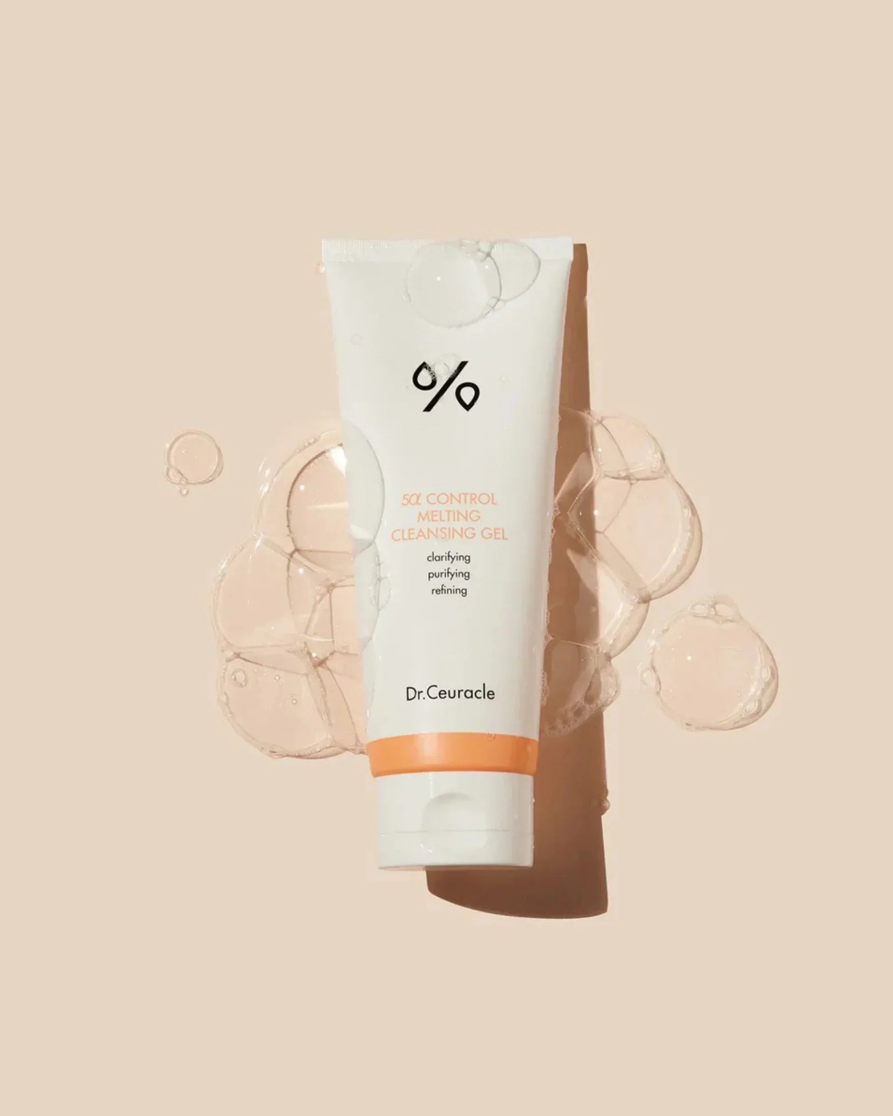 Dr. Ceuracle 5α Control Melting Cleansing Gel tube with bubbles on beige background
