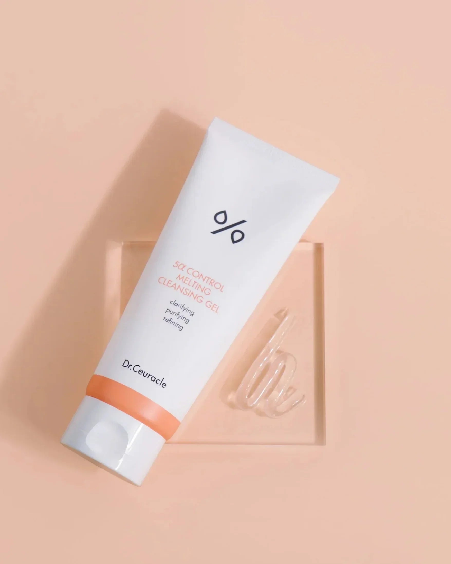 Dr.Ceuracle 5α Control Melting Cleansing Gel tube on peach background with clear gel swirl