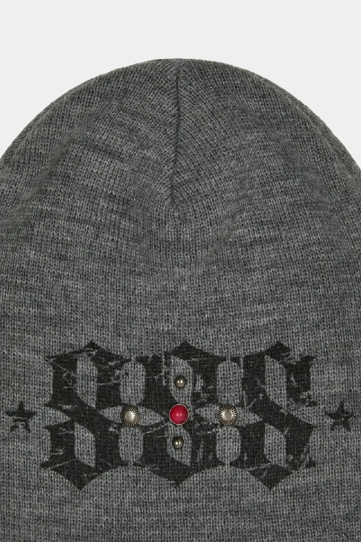 Grey knit beanie with black gothic text and metal stud embellishments including a red center stud