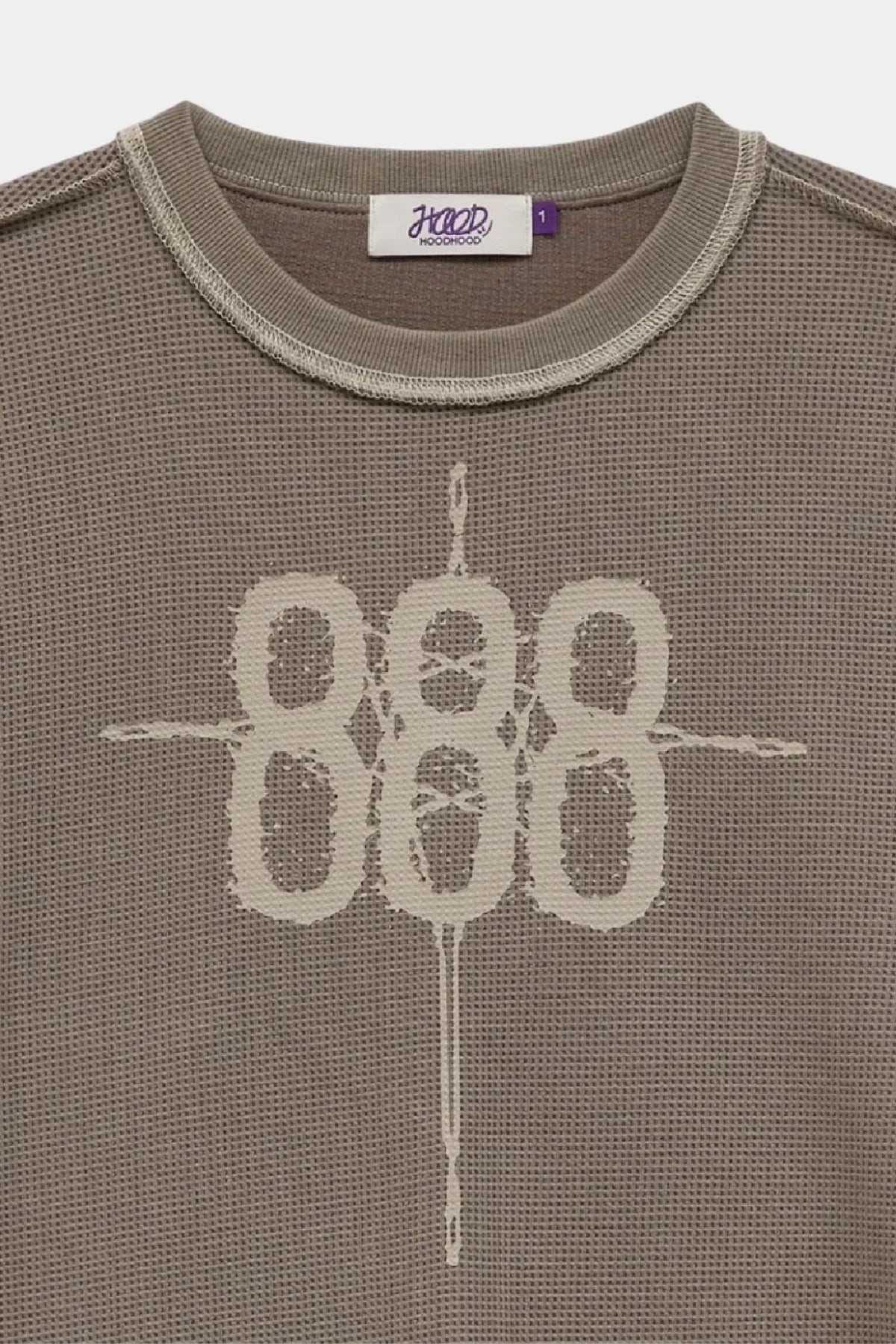 Close-up of greyish beige waffle long sleeve T-shirt with 888 graphic and ribbed neckline