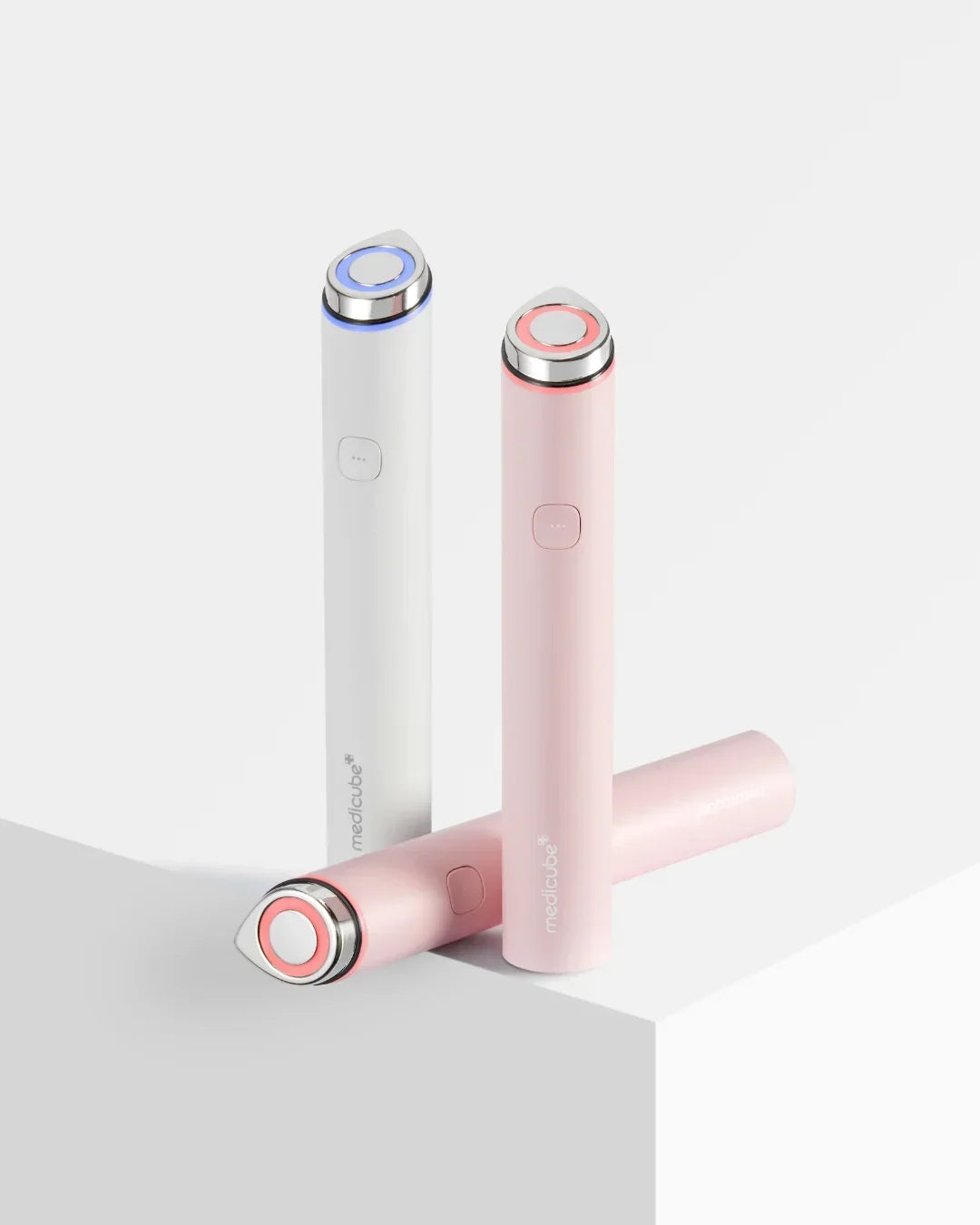 MediCube Age-R Booster Pro Mini Korean beauty devices in pink and white, minimal studio setting.