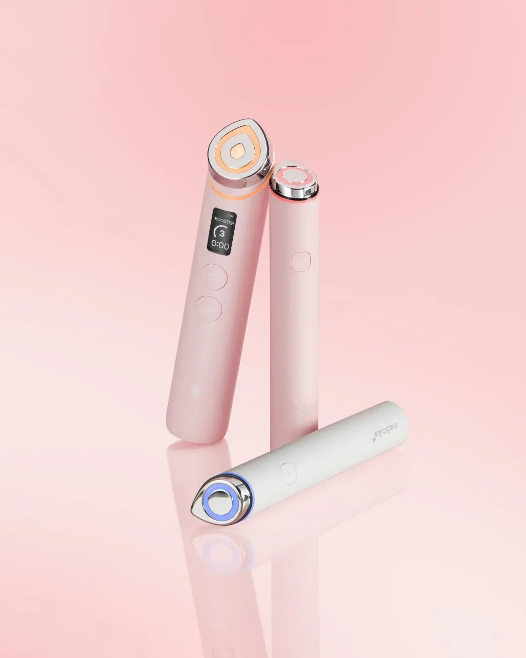 Three pink and white Korean beauty booster devices on a pink background, Malkn lifestyle platform