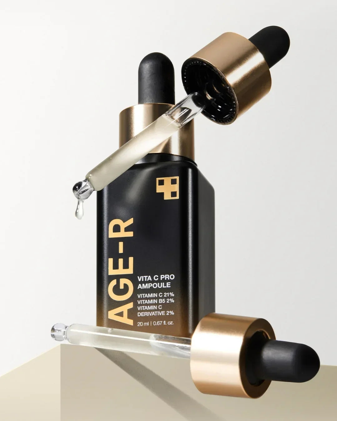 AGE-R Vita C Pro Ampoule serum bottle with gold dropper and vitamin C skincare product