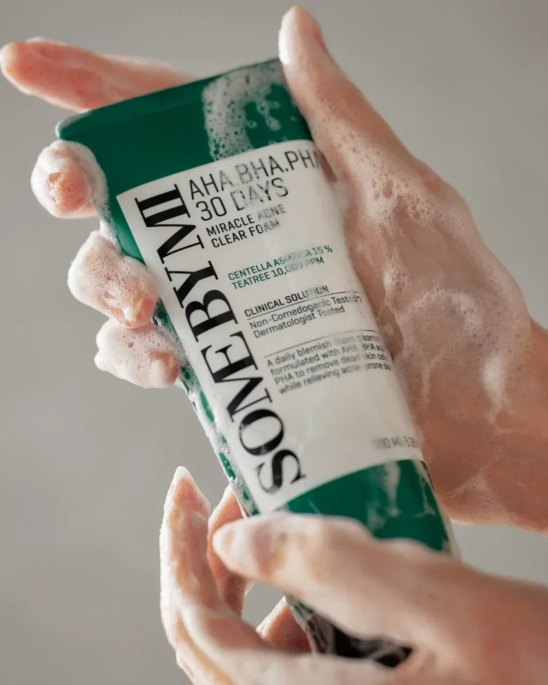 Hands lathered with foam holding a SON&TYNL AHA BHA PHA 30 Days Miracle Acne Clear Foam cleanser