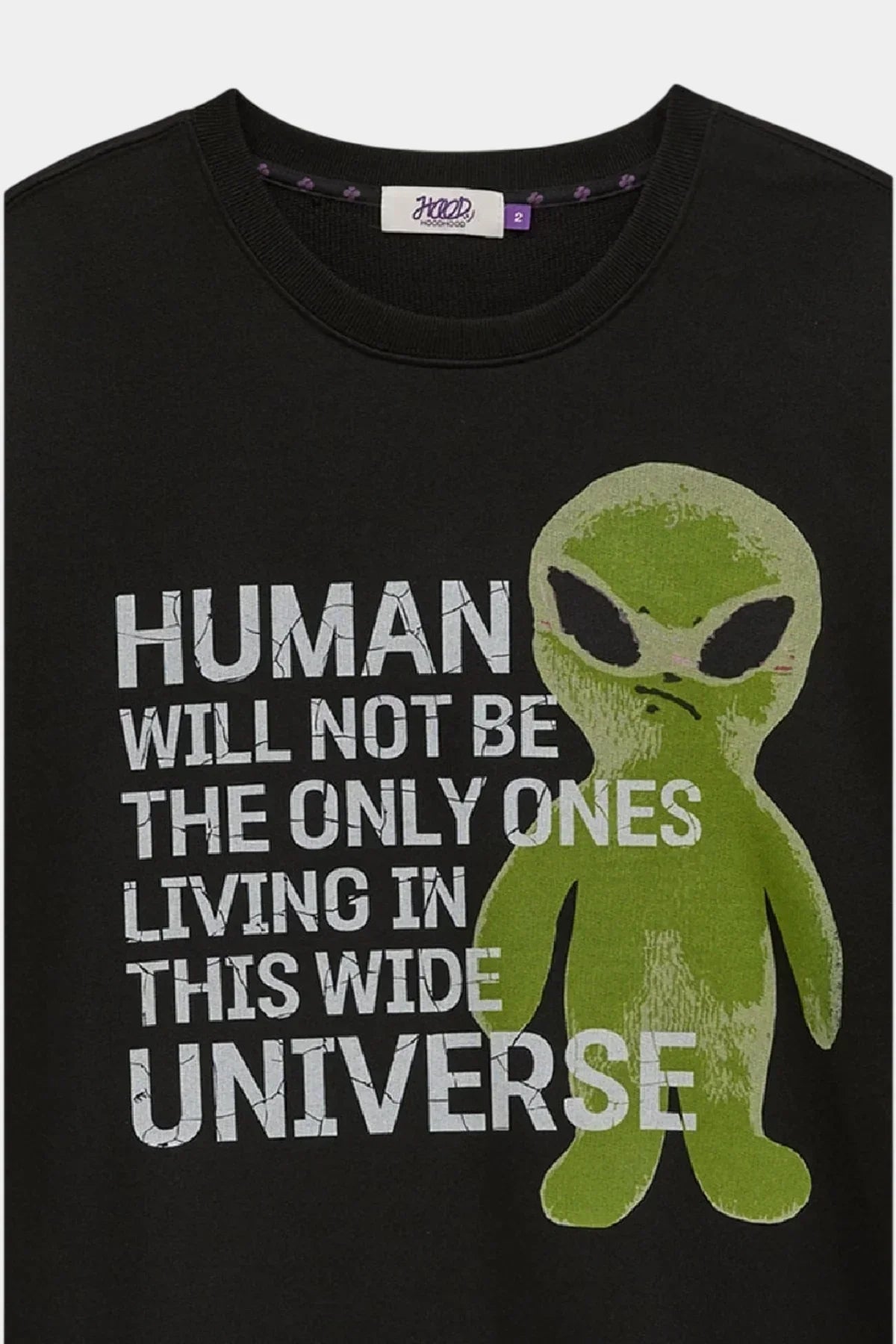Black sweatshirt with green alien graphic and white slogan text about humans in the universe