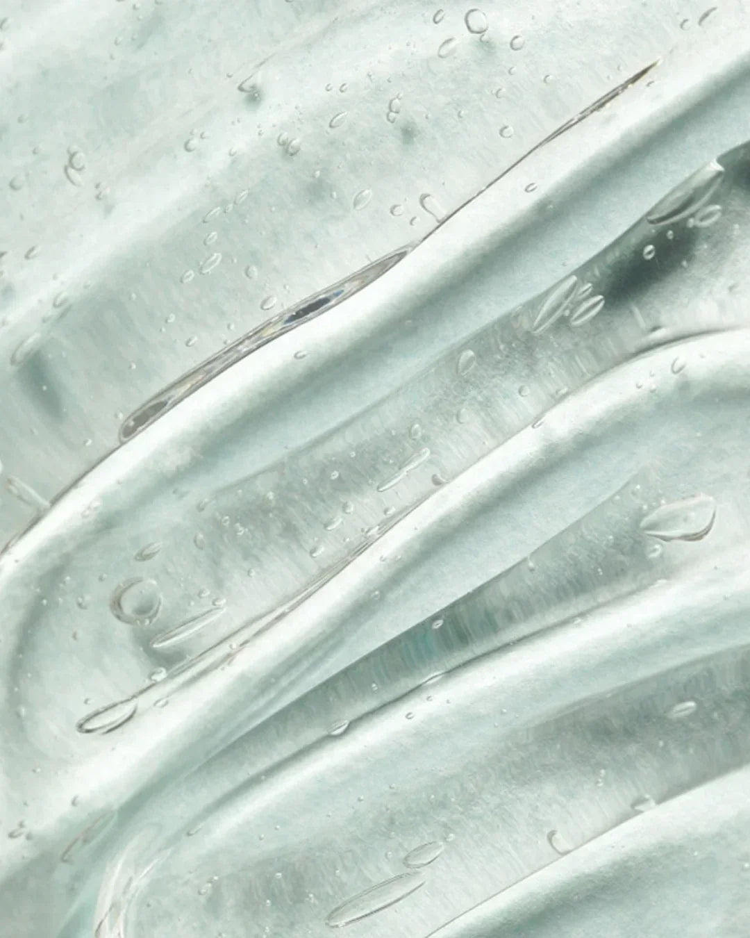 Close-up of clear aloe vera gel texture with hydration droplets