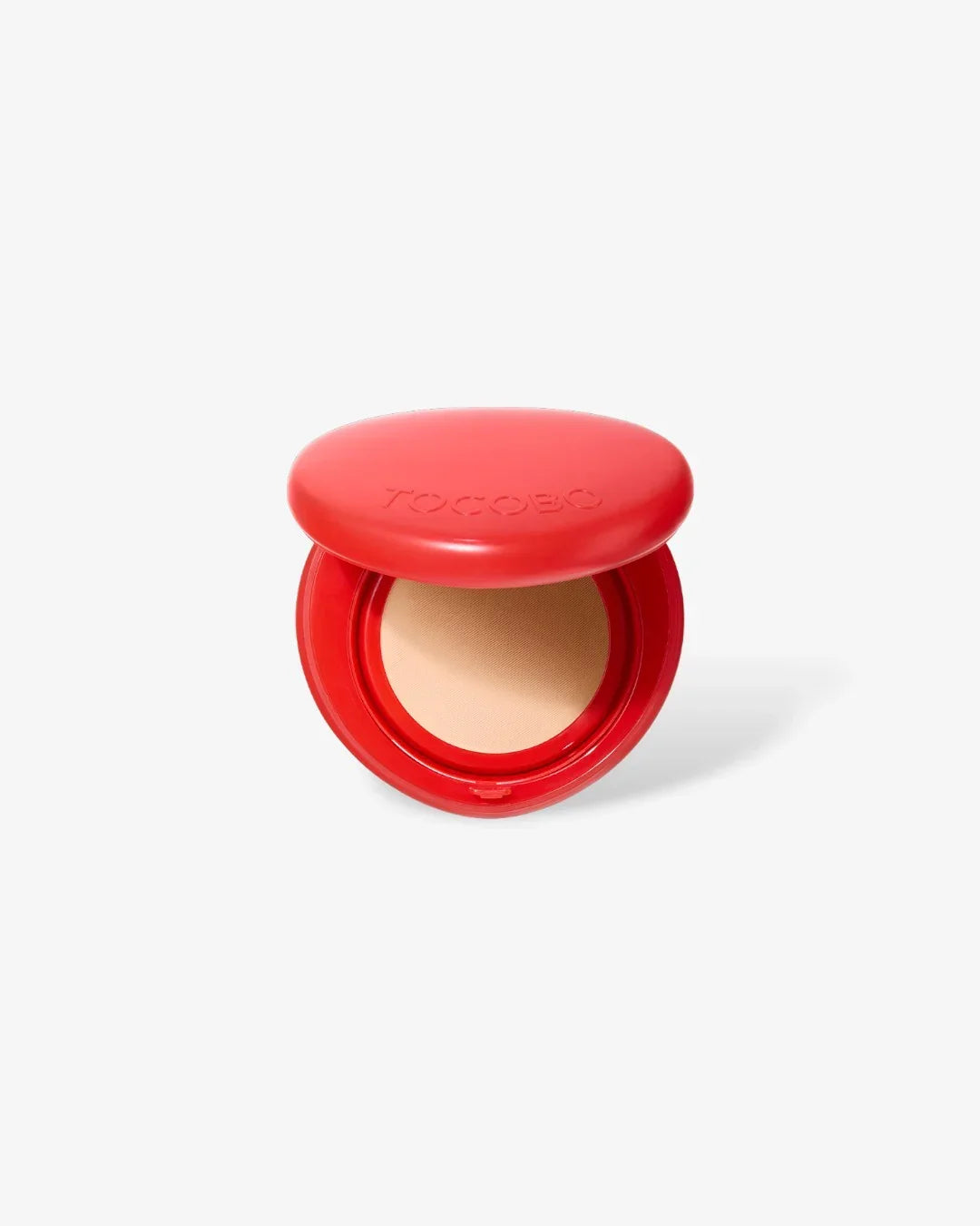 Open red compact case with beige face cushion foundation on white background