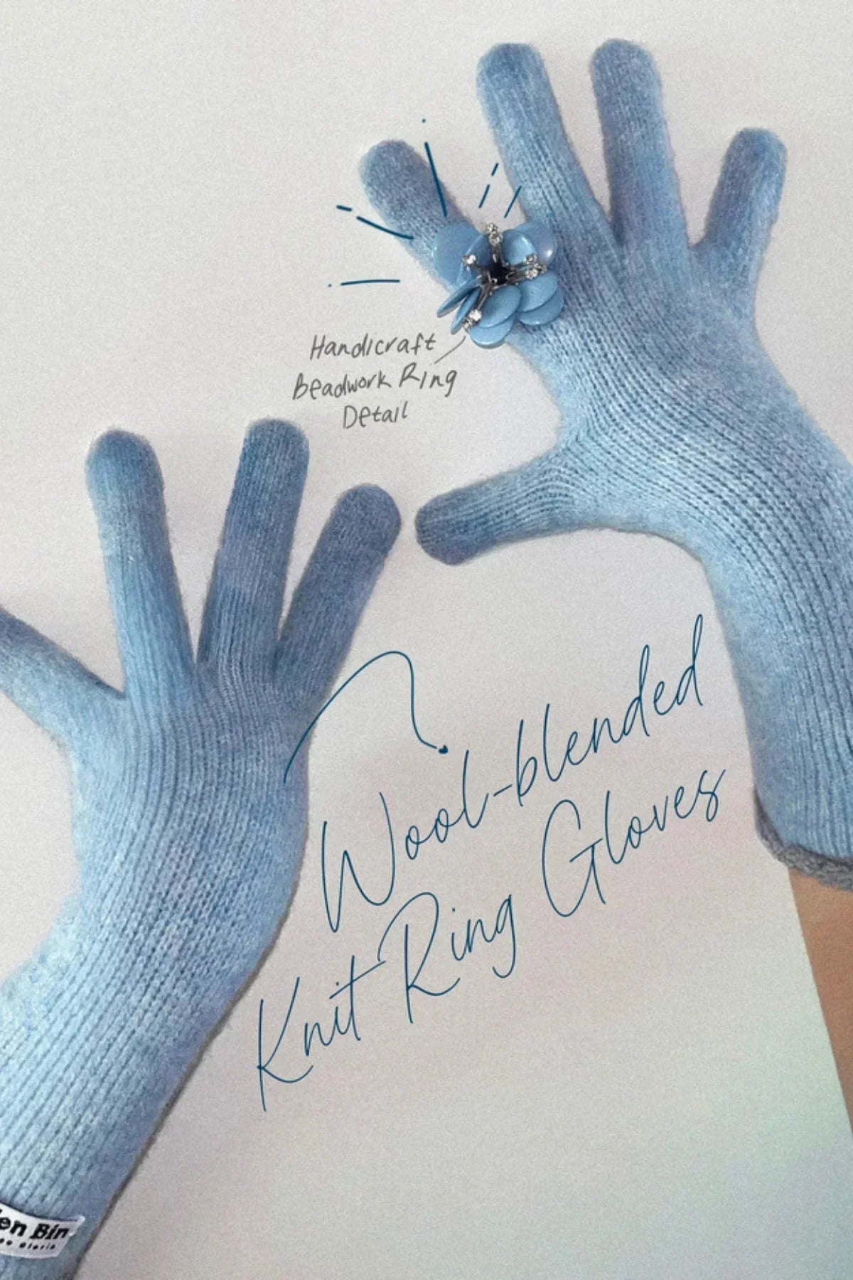 Light blue wool-blended knit gloves featuring a handcrafted beaded flower ring detail on the right hand