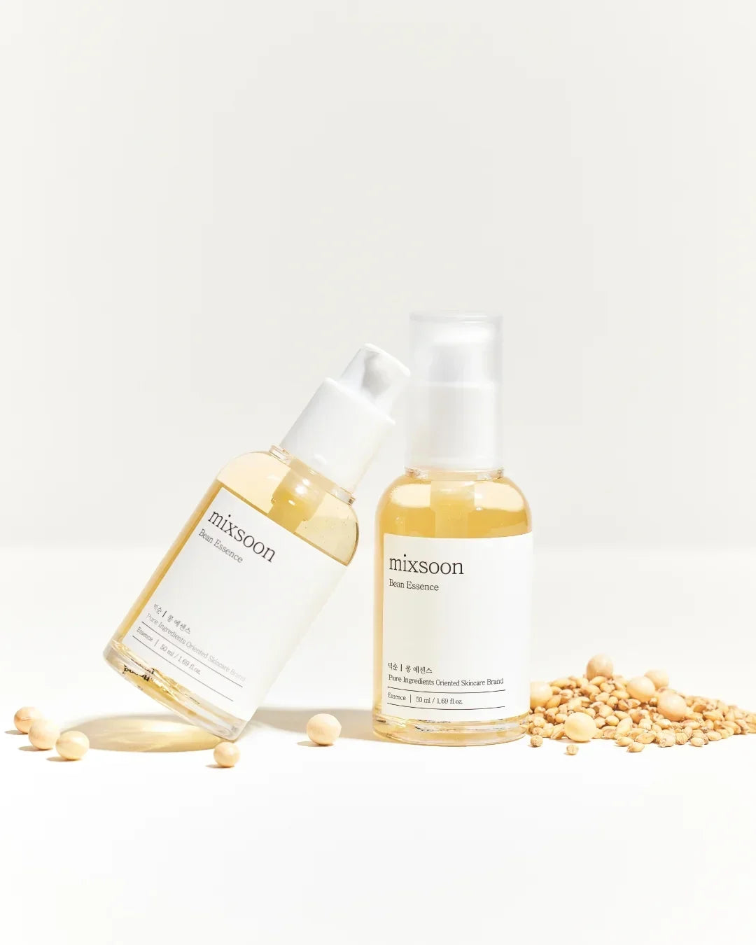 Mixsoon Bean Essence skincare bottles with soybeans and grains on white background