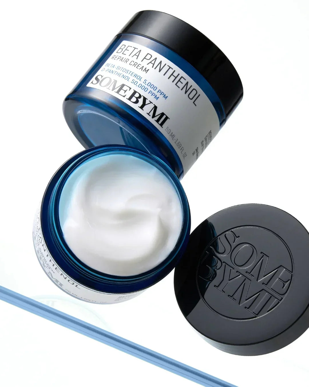 Open blue jar of SOME BY MI Beta Panthenol Repair Cream with white cream inside, black lid on side