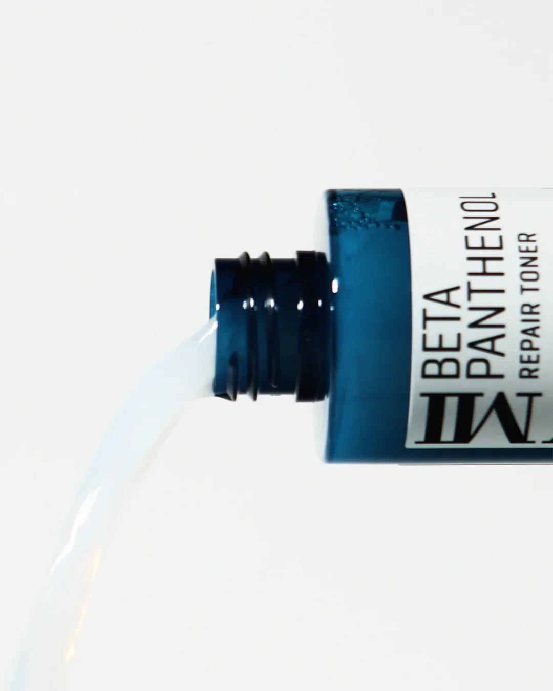Blue bottle of Beta Panthenol Repair Toner pouring clear liquid against white background