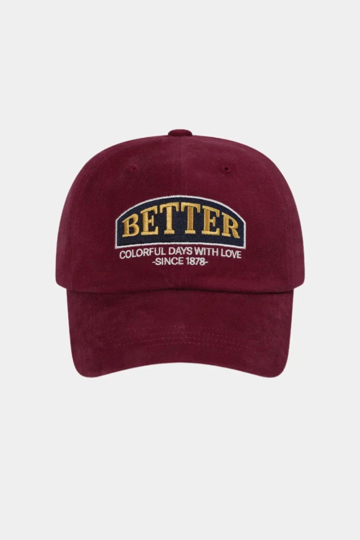 Burgundy baseball cap with embroidered text 'BETTER Colorful Days With Love Since 1878' on front
