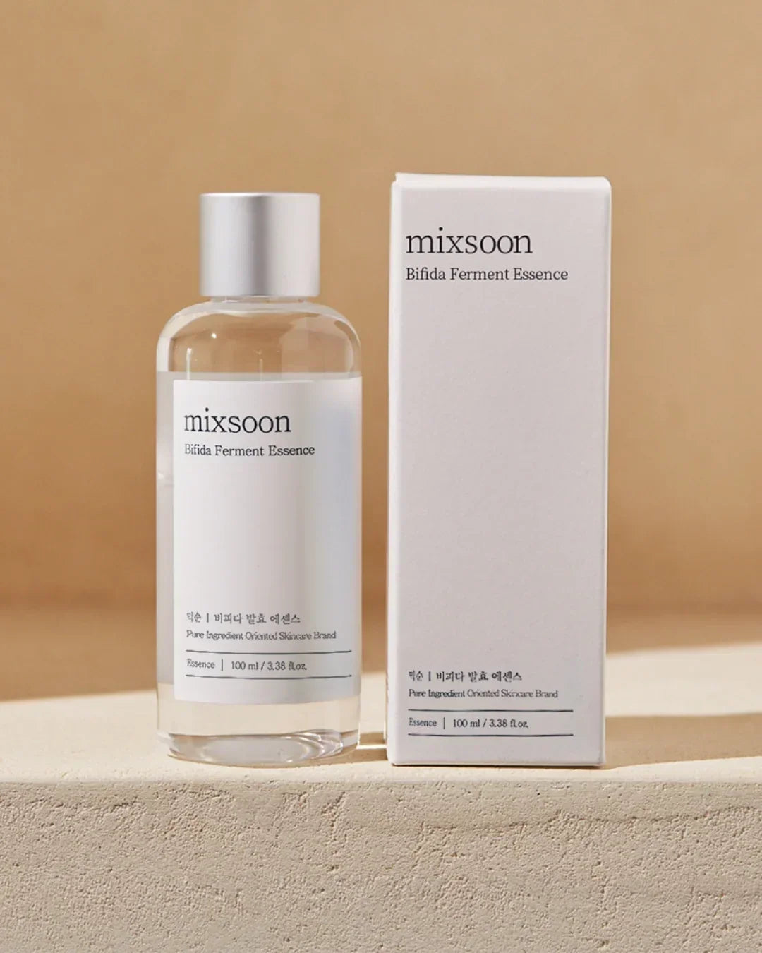 Mixsoon Bifida Ferment Essence skincare bottle and white box packaging on beige surface
