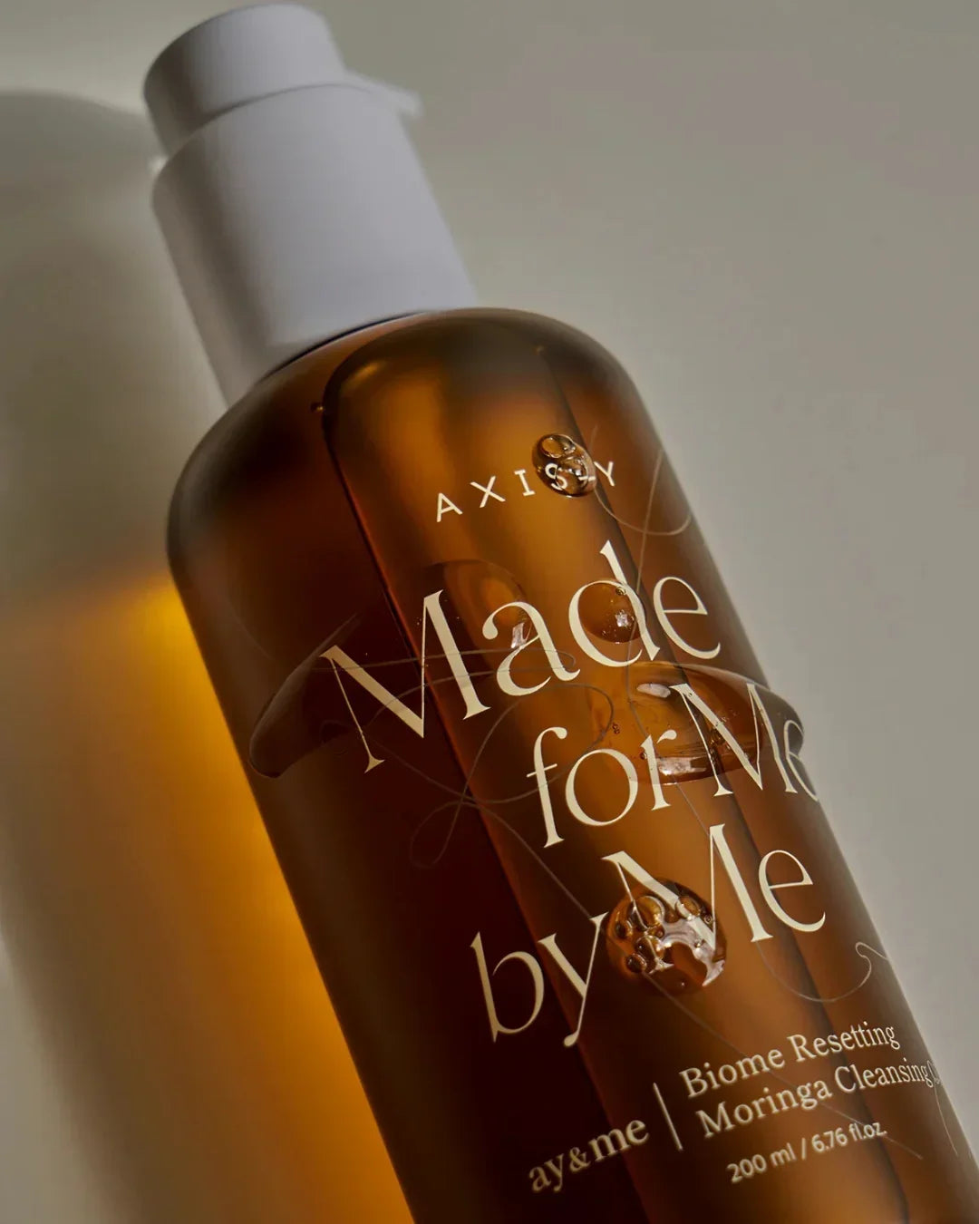 Close-up of brown bottle with white pump labeled Biome Resetting Moringa Cleansing Oil 200ml