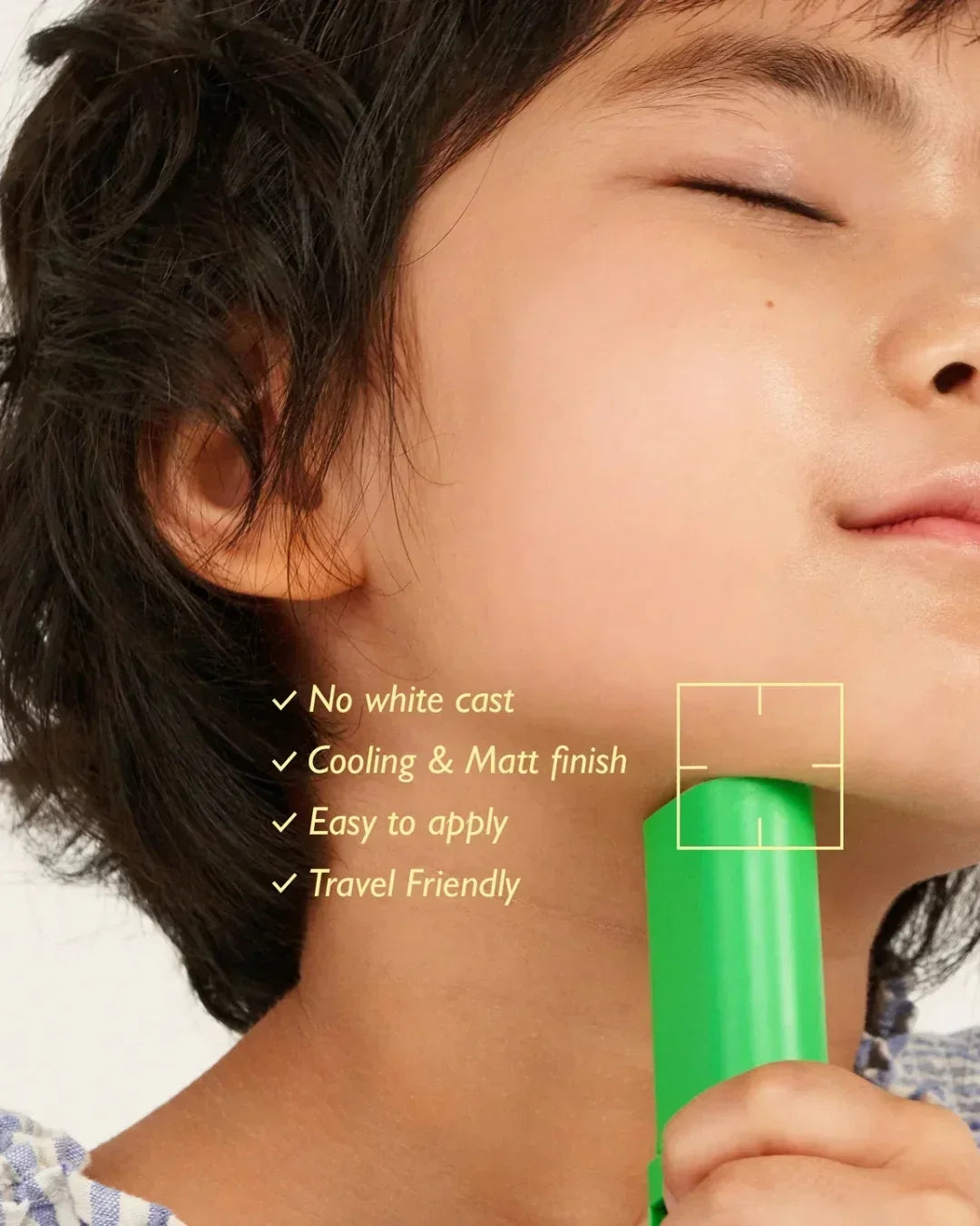 Close-up of smiling person with clear skin holding green skincare product, highlighting no white cast and matt finish