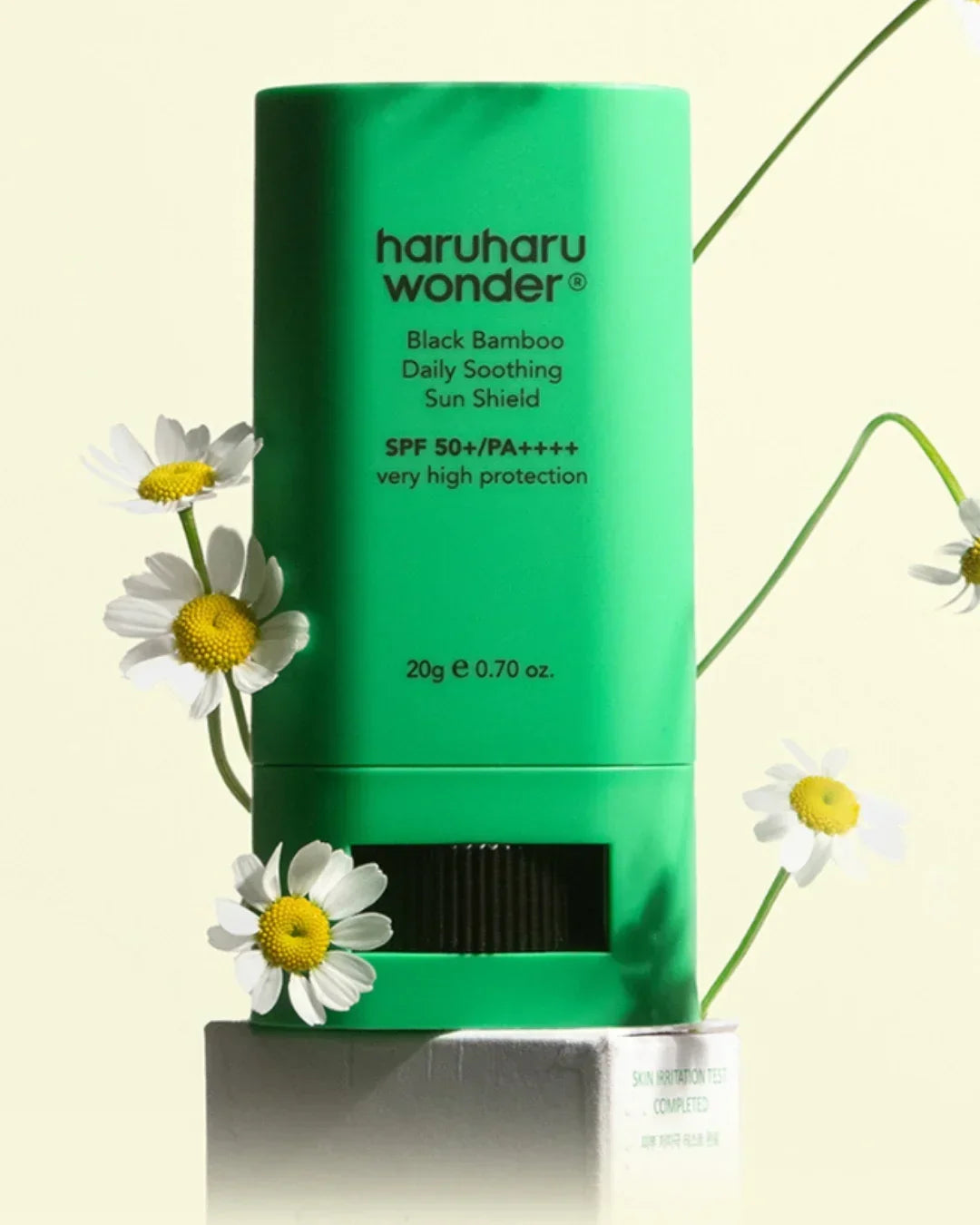 Green Haruharu Wonder Black Bamboo Daily Soothing Sun Shield SPF 50+ sunscreen with white daisies