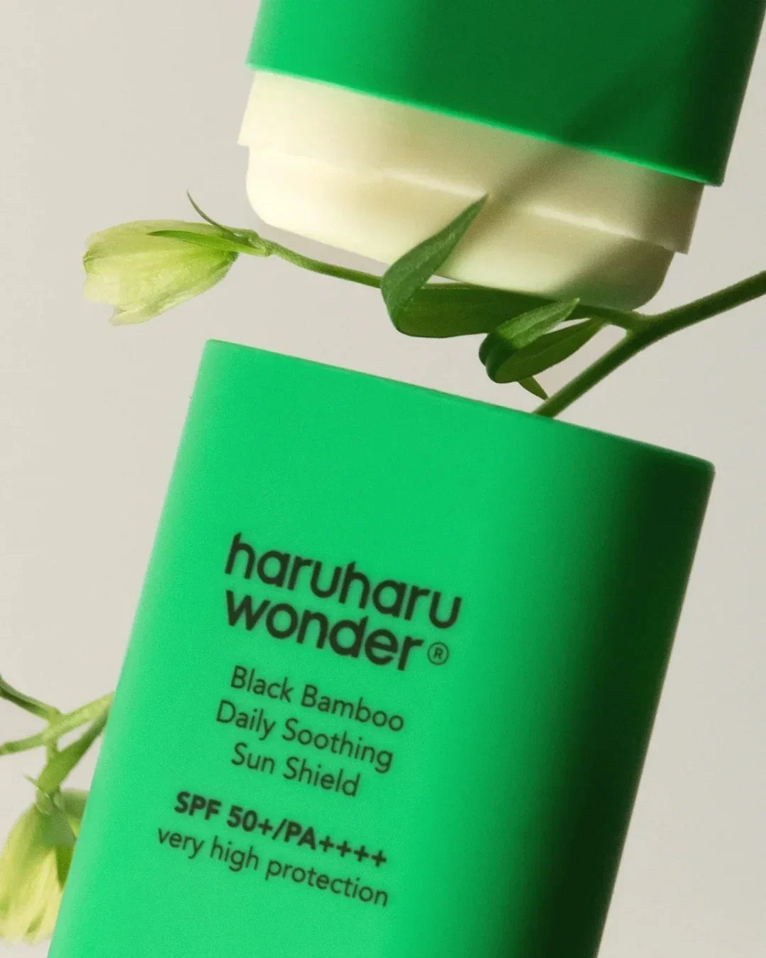 Green tube of haruharu wonder Black Bamboo Daily Soothing Sun Shield SPF 50+/PA++++ with plant details