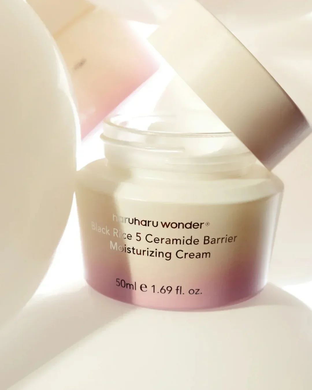 Open jar of haruharu wonder Black Rice 5 Ceramide Barrier Moisturizing Cream 50ml on white background
