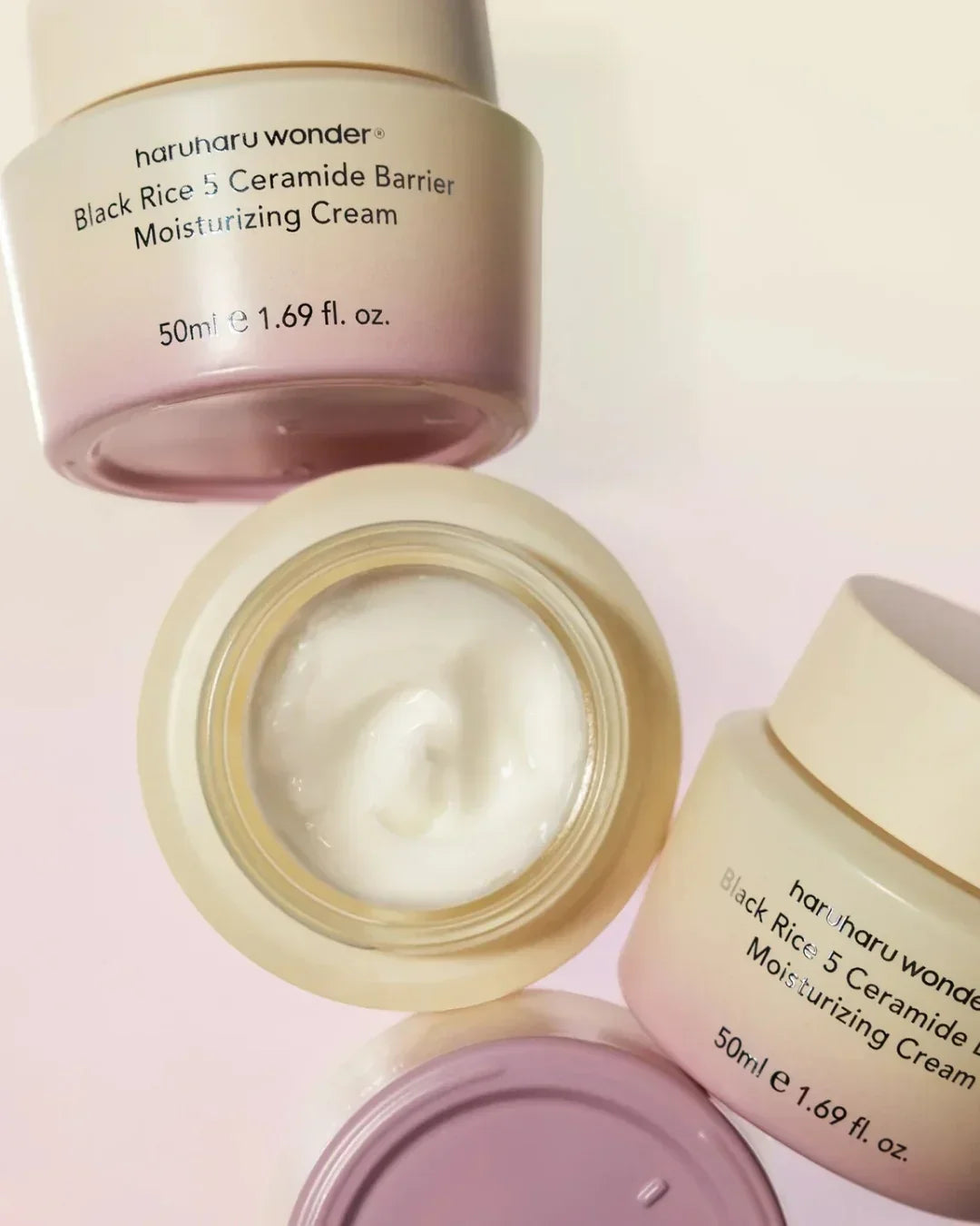 Open jars of Haruharu Wonder Black Rice 5 Ceramide Barrier Moisturizing Cream with white cream inside