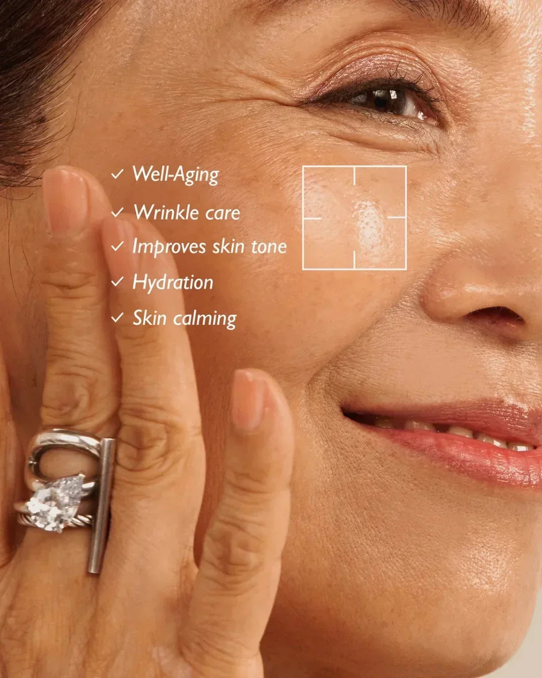 Close-up of mature woman’s face smiling, highlighting skin benefits like wrinkle care and hydration