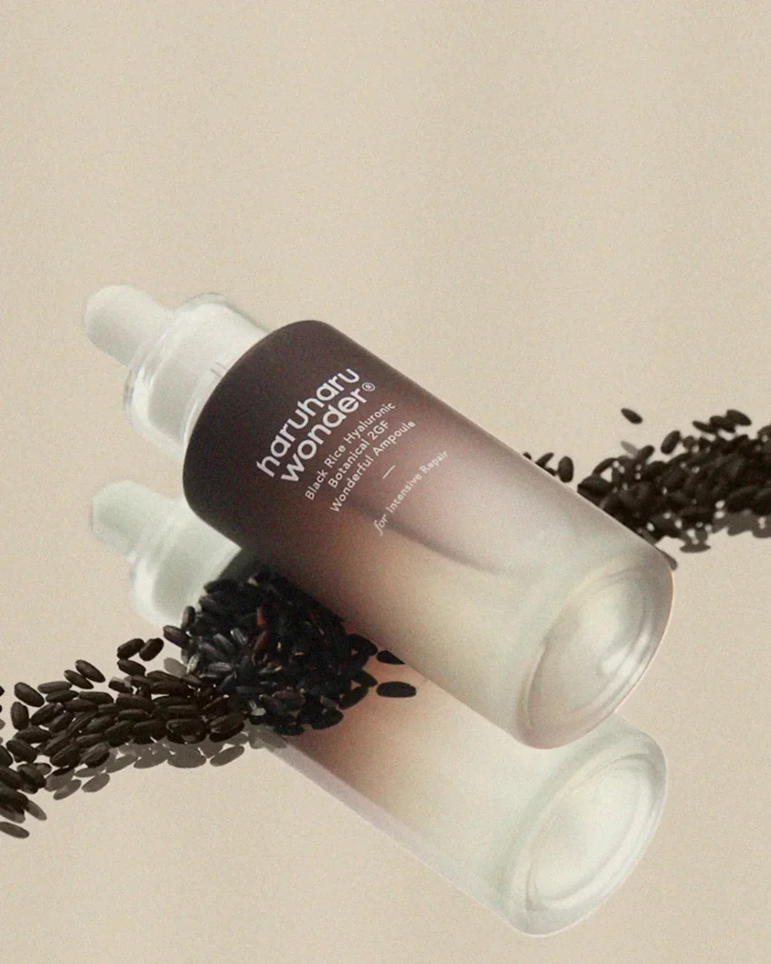 haruharu wonder Black Rice Hyaluronic Botanical 2GF ampoule bottle with black rice grains on reflective surface