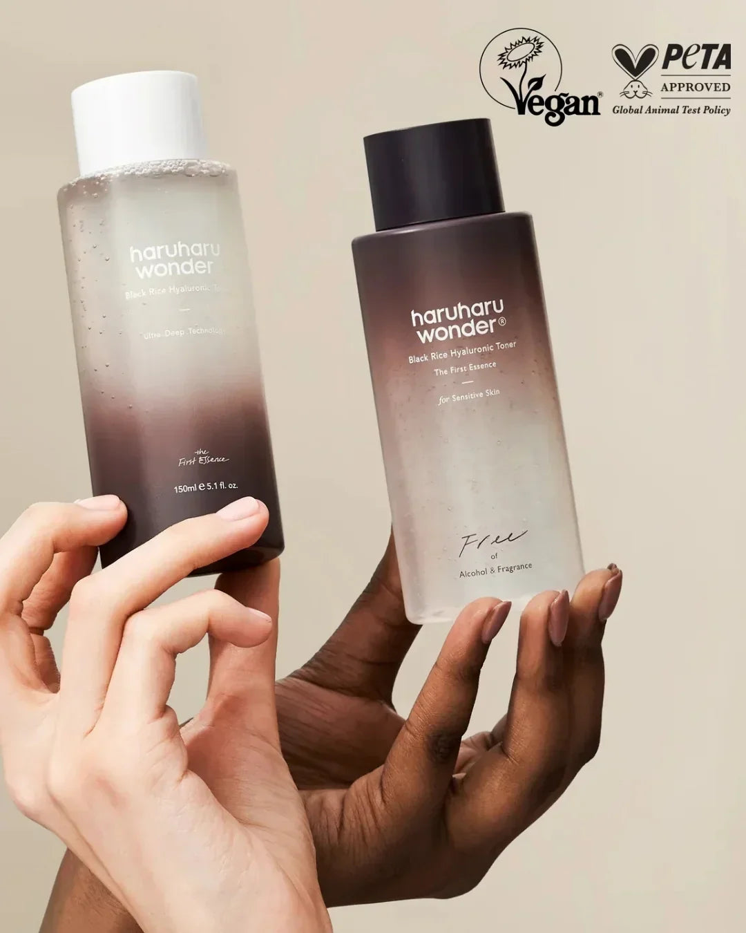 Hands holding Haruharu Wonder Black Rice Hyaluronic Toner bottles, vegan and PETA approved skincare
