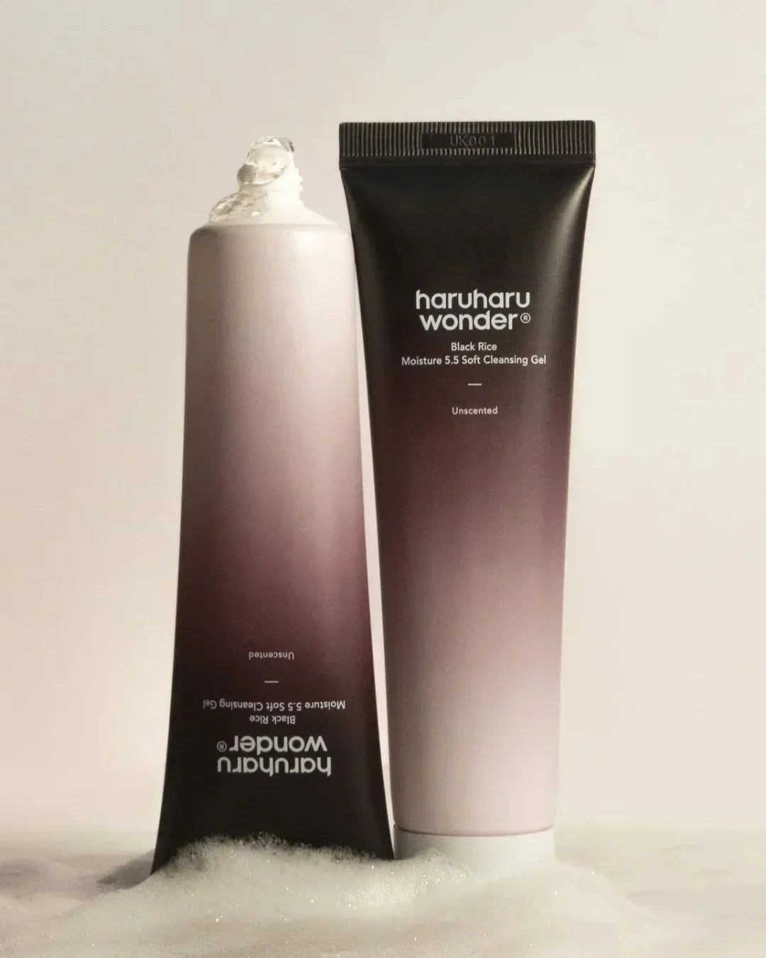 Two tubes of Haruharu Wonder Black Rice Moisture 5.5 Soft Cleansing Gel with foam on surface