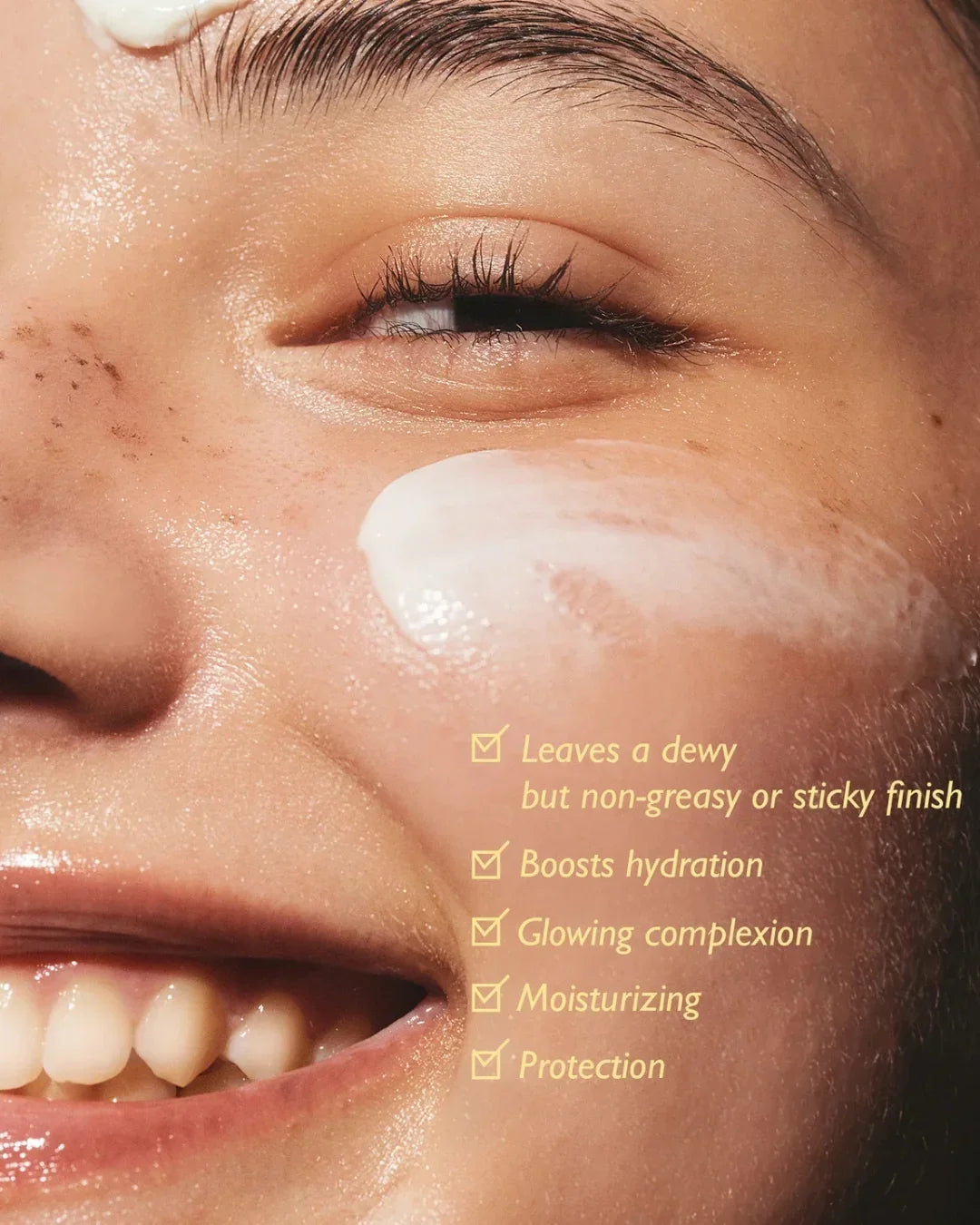 Close-up of a smiling model applying Black Rice Moisture Airyfit Daily Sunscreen, glowing skin