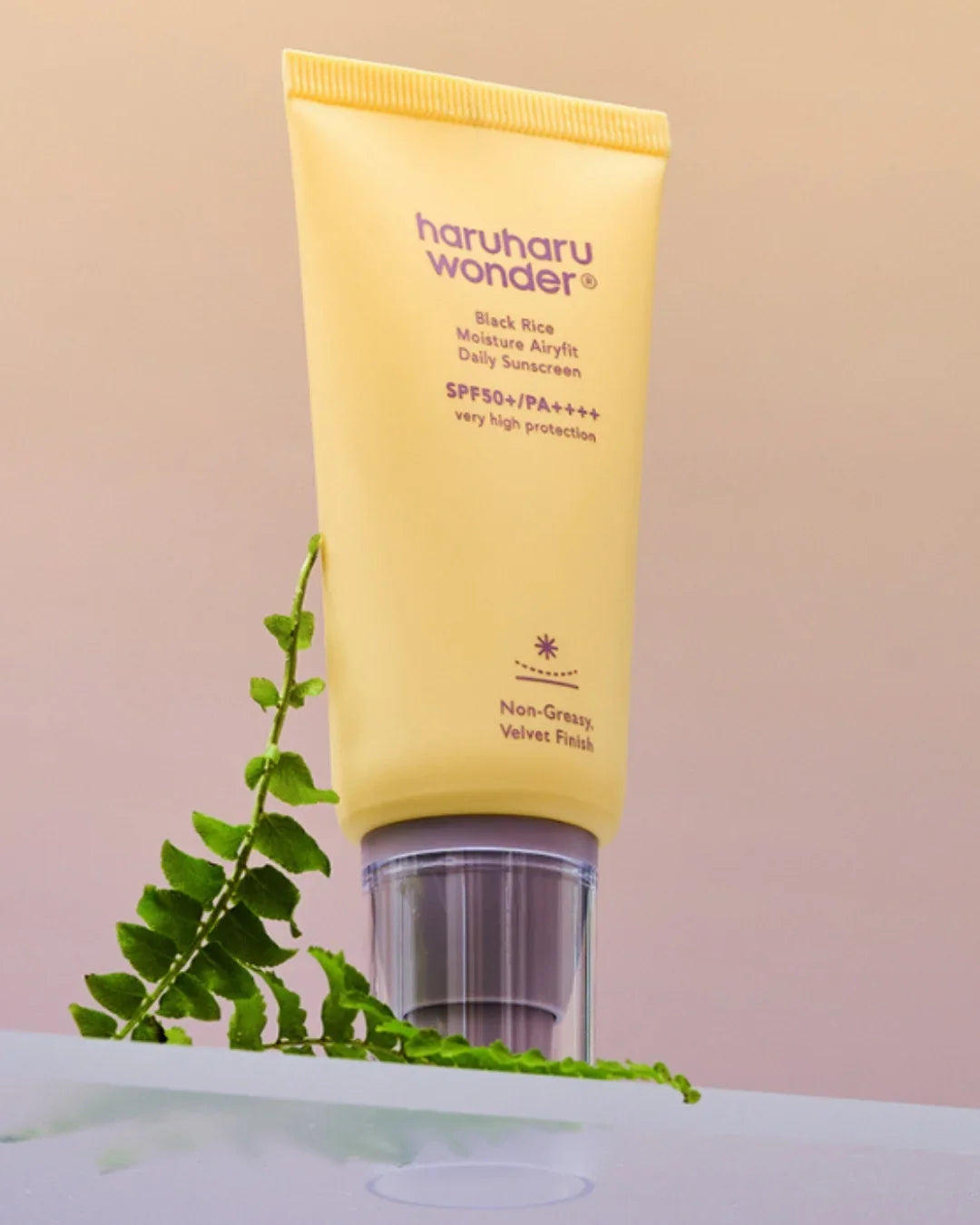 Haruharu Wonder Black Rice Moisture Airyfit Daily Sunscreen SPF50+ tube on pastel background, Korean beauty skincare, Malkn UK