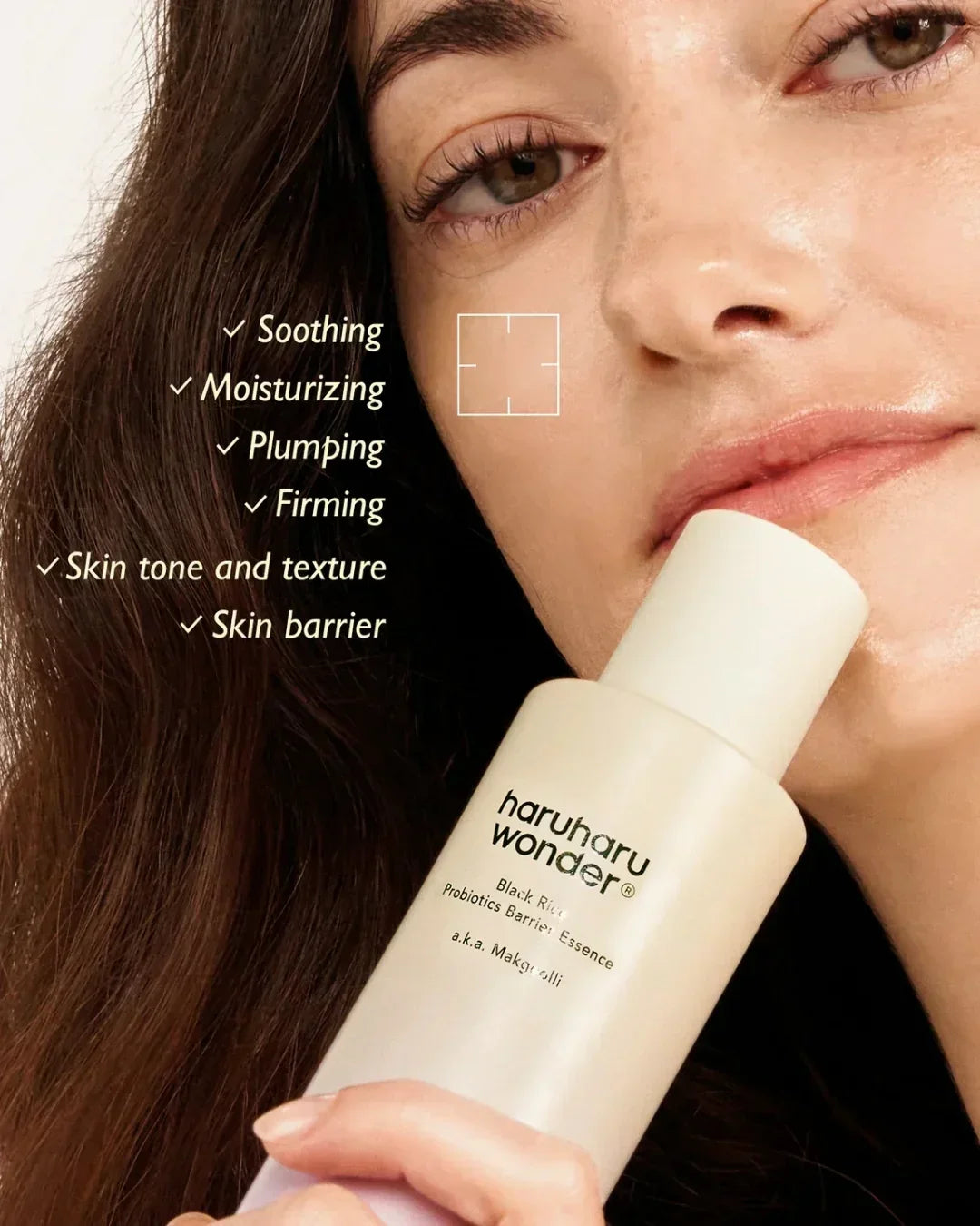 Woman holding Haruharu Wonder Black Rice Probiotics Barrier Essence with glowing skin