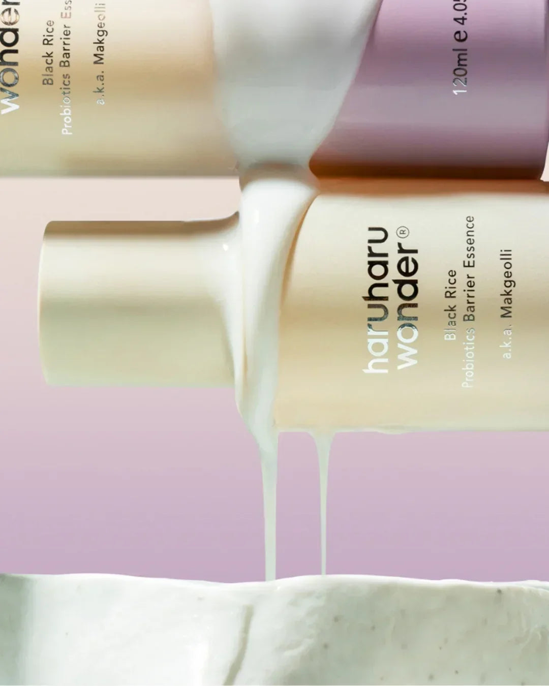 Two Haruharu Wonder Black Rice Probiotics Barrier Essence bottles with white liquid dripping over pastel purple background