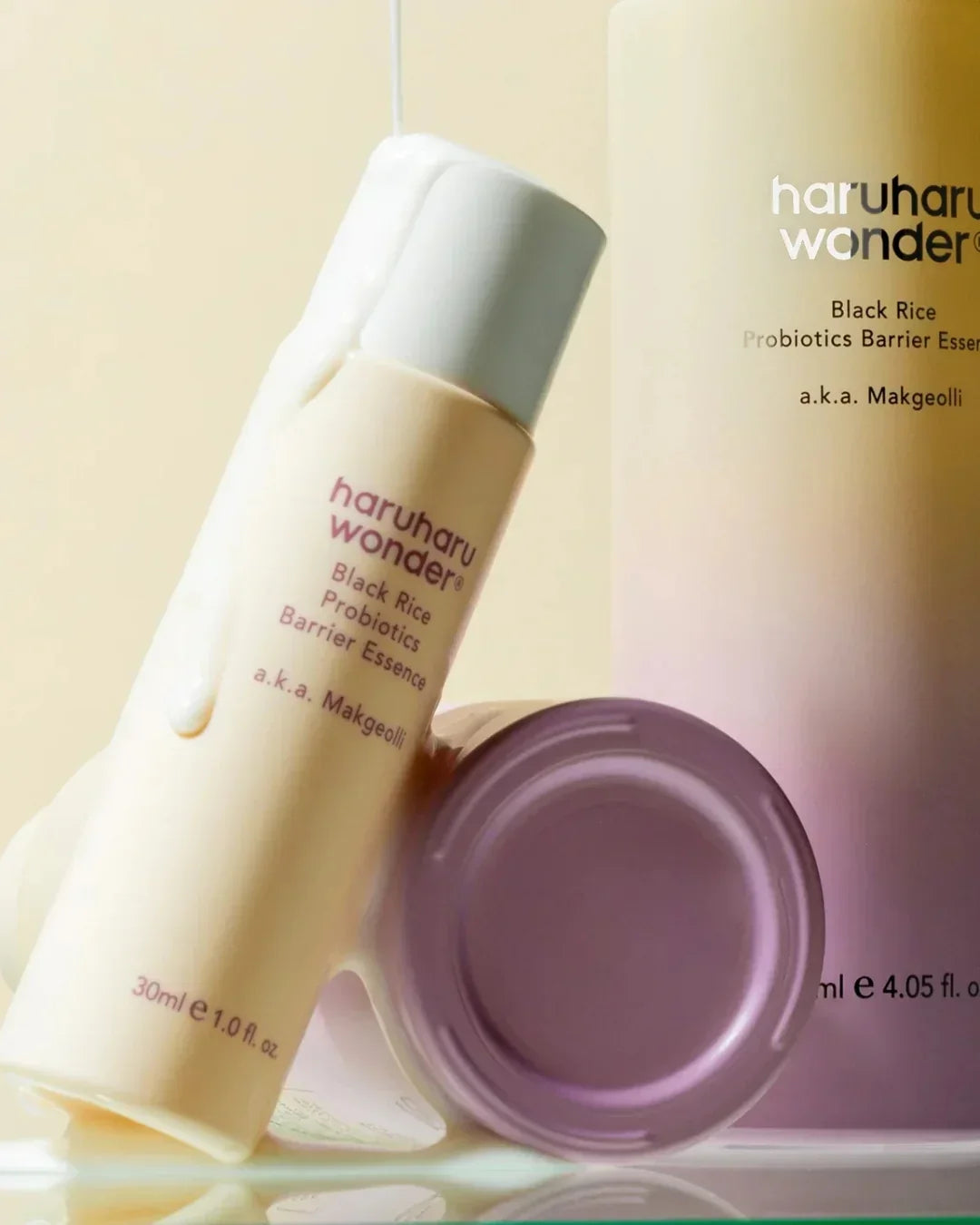 haruharu wonder Black Rice Probiotics Barrier Essence bottle with cream on light beige and purple pastel background