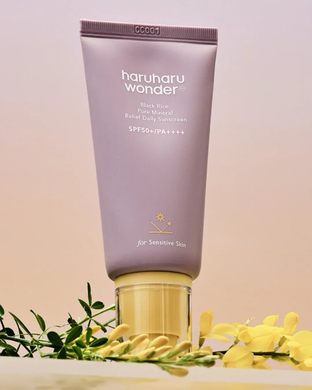 Haruharu Wonder Black Rice Pure Mineral Relief Daily Sunscreen SPF50+ for sensitive skin, displayed with yellow flowers, Korean beauty skincare, Malkn UK.