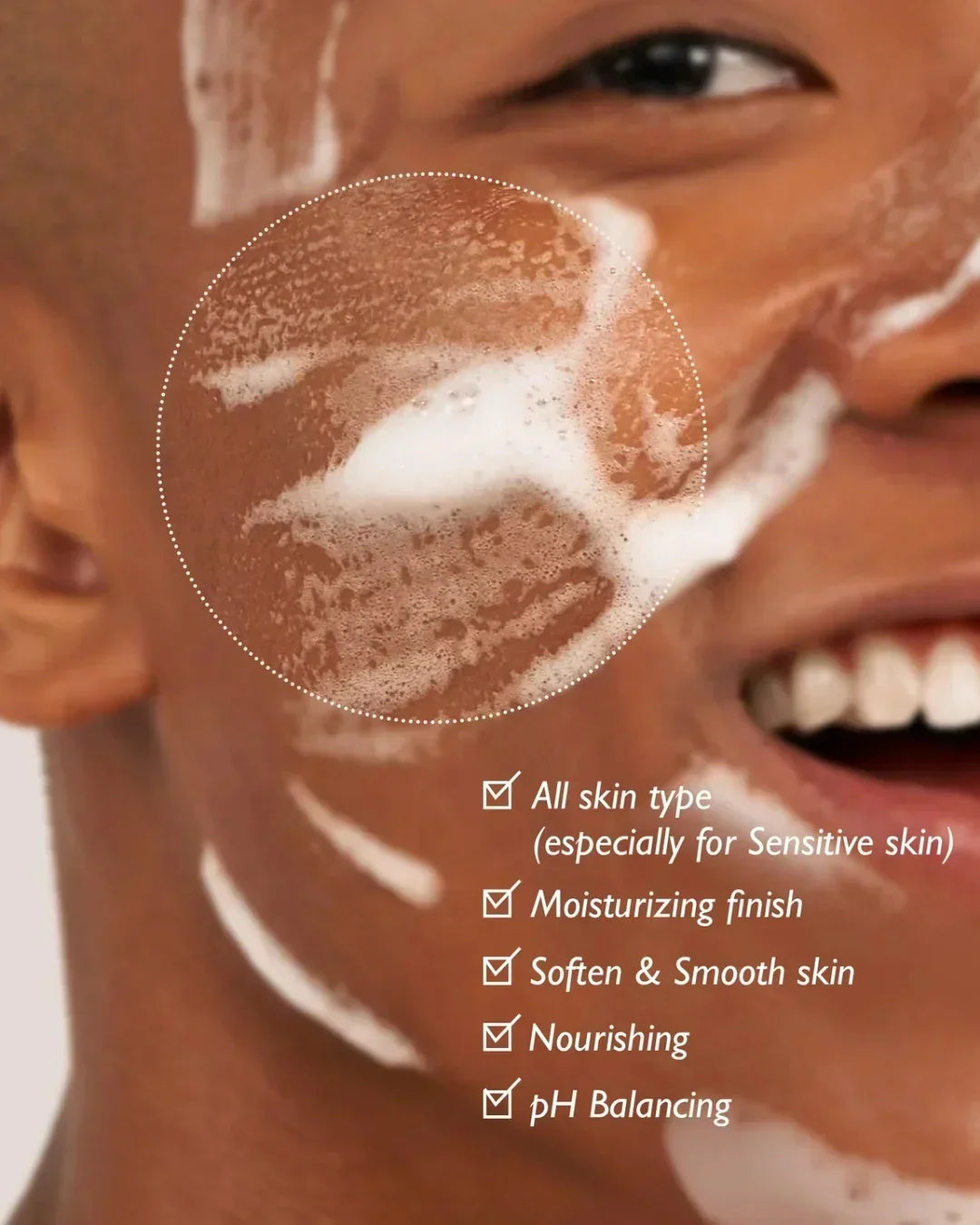 Close-up of smiling person with foamy cleansing gel on face, highlighting skincare benefits