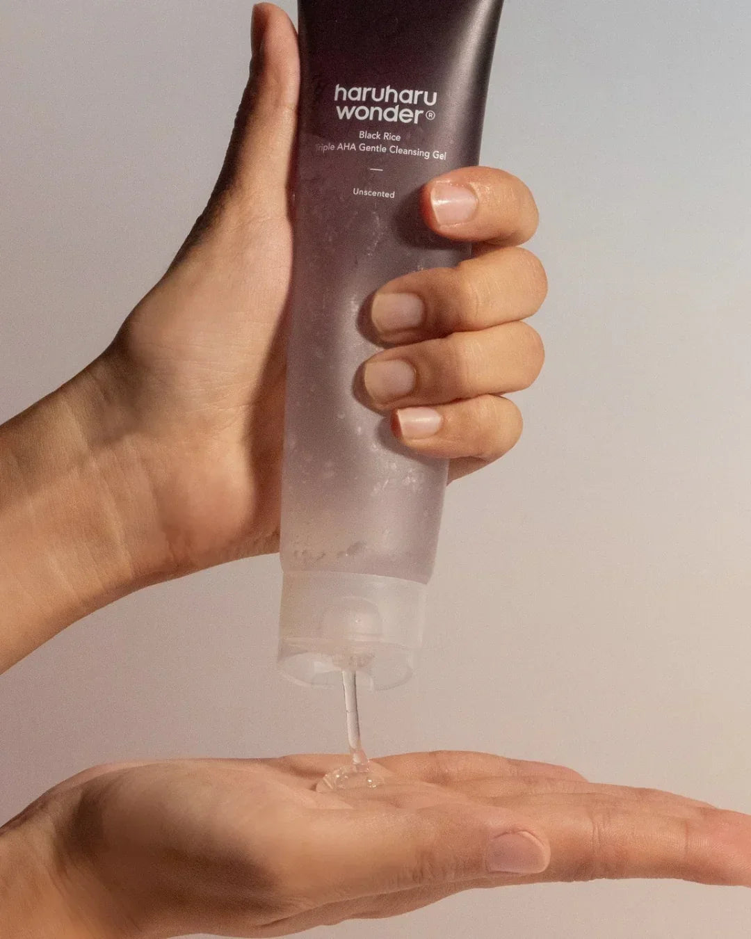 Hand dispensing Haruharu Wonder Black Rice Triple AHA Gentle Cleansing Gel, skincare product