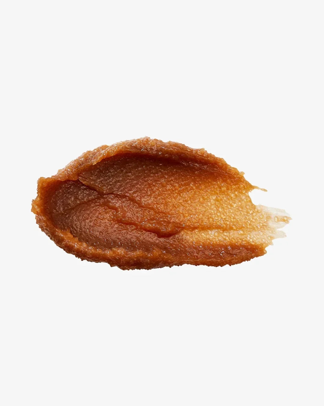 Close-up texture of brown black sugar scrub on white background