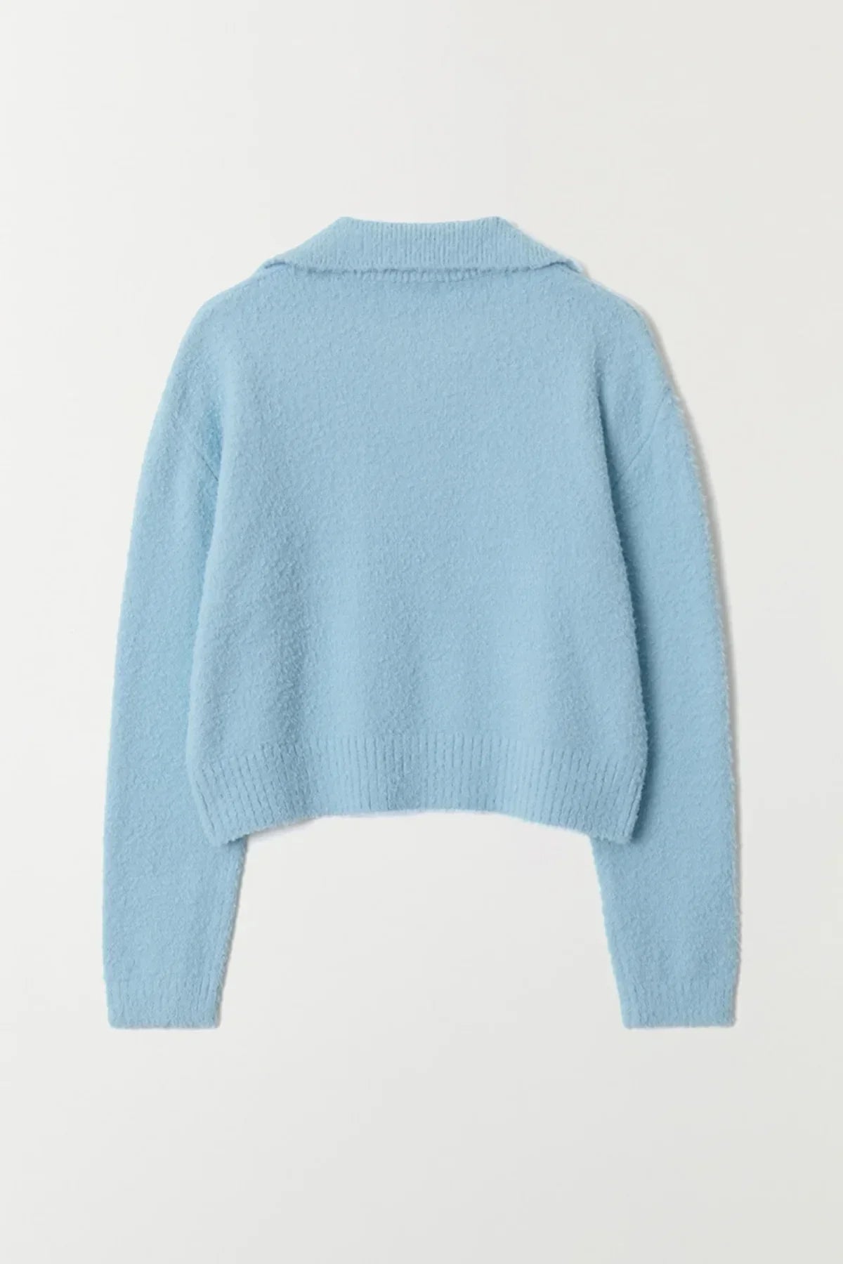 Back view of sky blue boucle knit sweater with long sleeves and ribbed hem