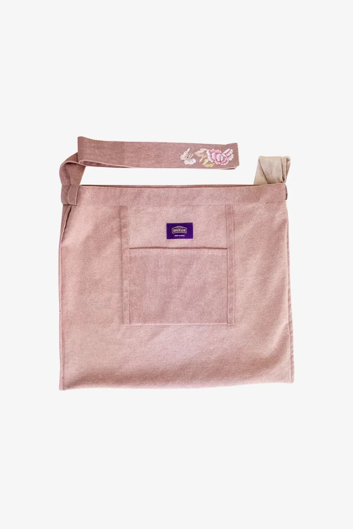 Pink fabric daily bag with front pocket and adjustable strap featuring floral embroidery