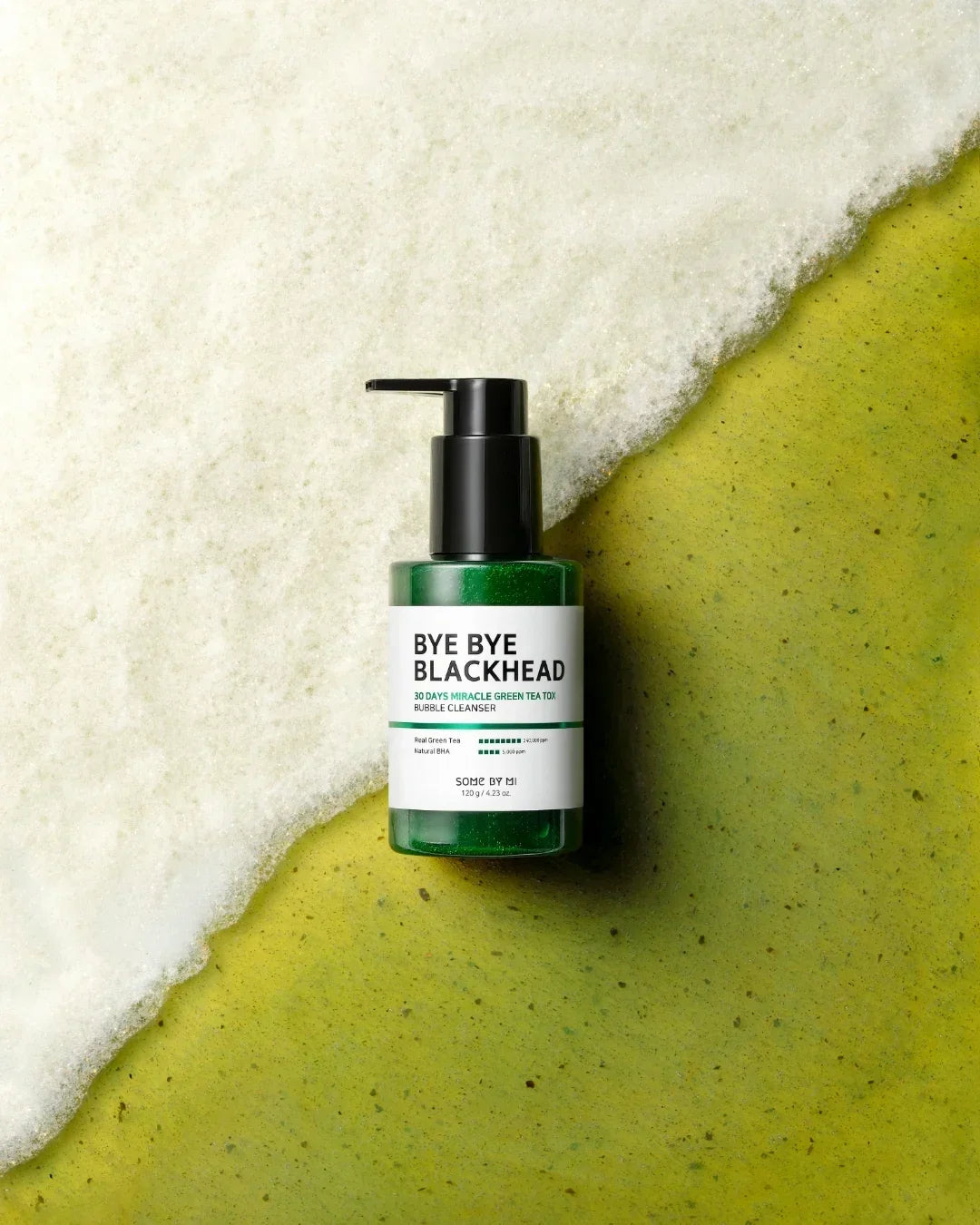 Bye Bye Blackhead 30 Days Miracle Green Tea Tox Bubble Cleanser bottle with foam on green textured surface