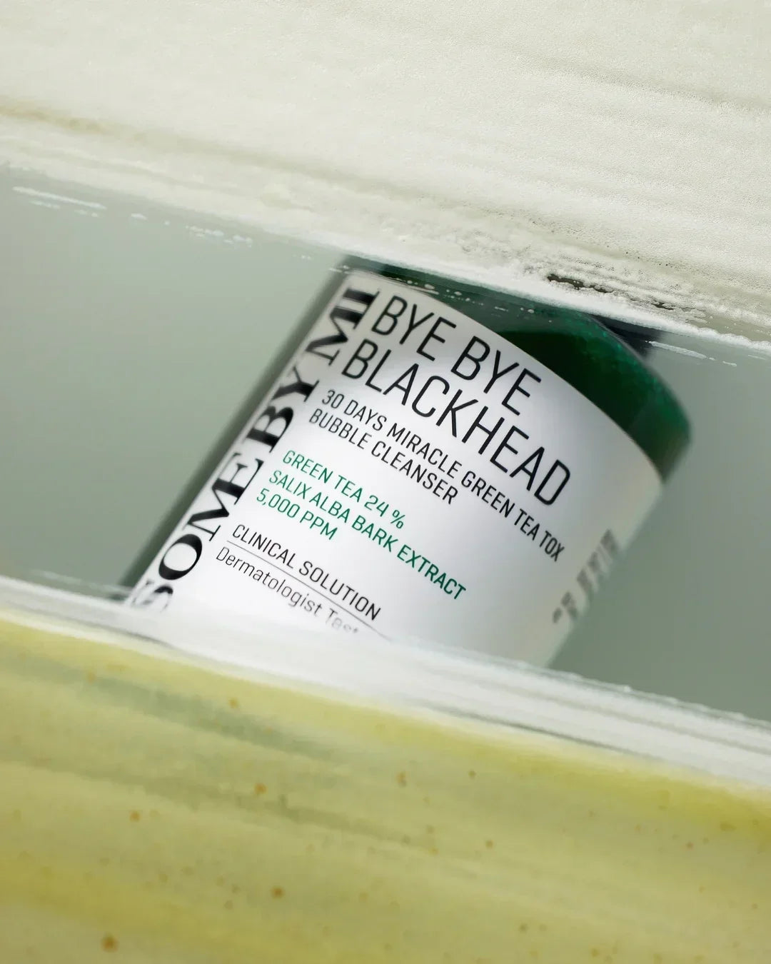 Some By Mi Bye Bye Blackhead 30 Days Miracle Green Tea Tox Bubble Cleanser jar in a clear display case