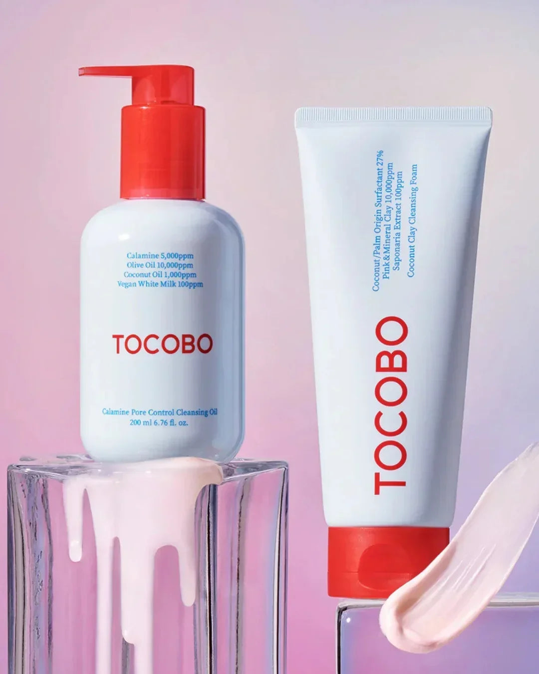 Tocobo Calamine Pore Control Cleansing Oil with red pump and Tocobo Coconut Clay Cleansing Foam tube on glass blocks with pink cream smear
