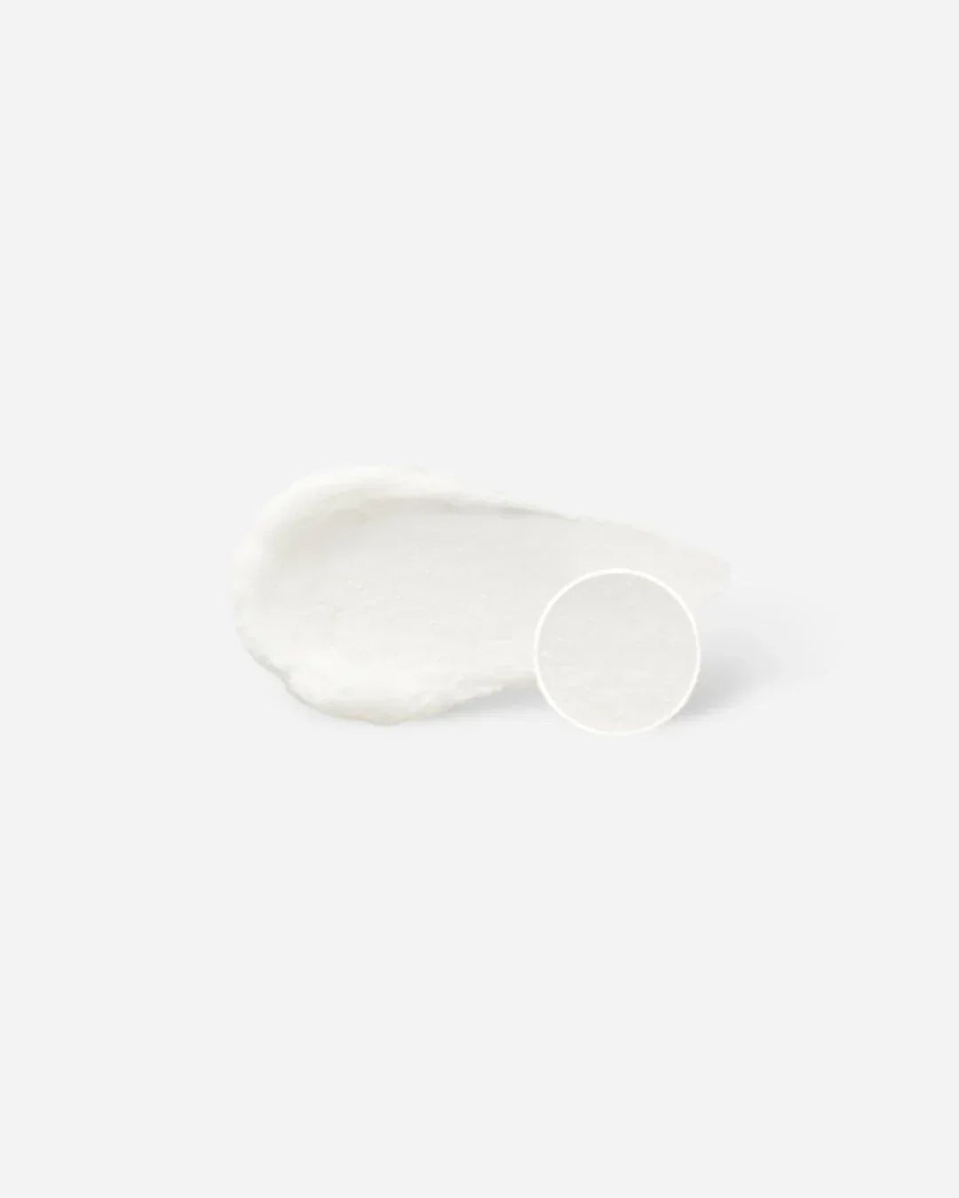 White creamy texture sample of carrot carotene balancing cleansing foam on light background