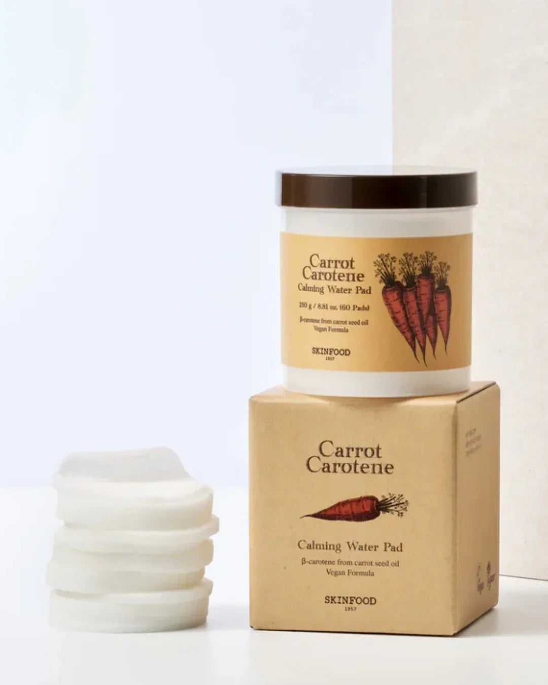 Skinfood Carrot Carotene Calming Water Pads with jar, box, and stacked cotton pads