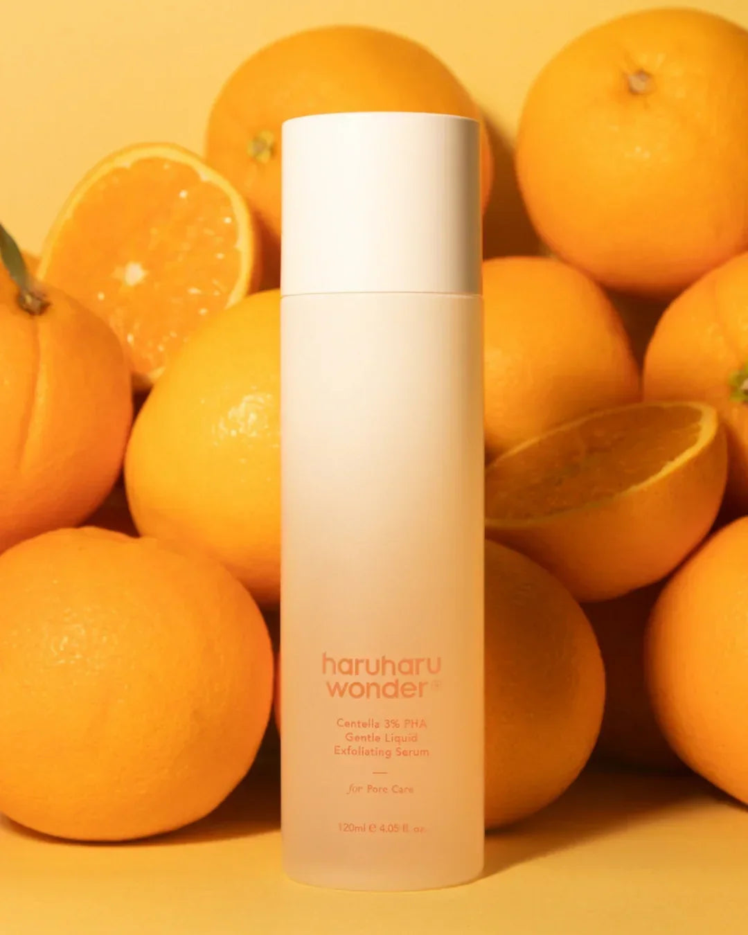 Haruharu Wonder Centella 3% PHA gentle liquid exfoliating serum bottle surrounded by fresh oranges