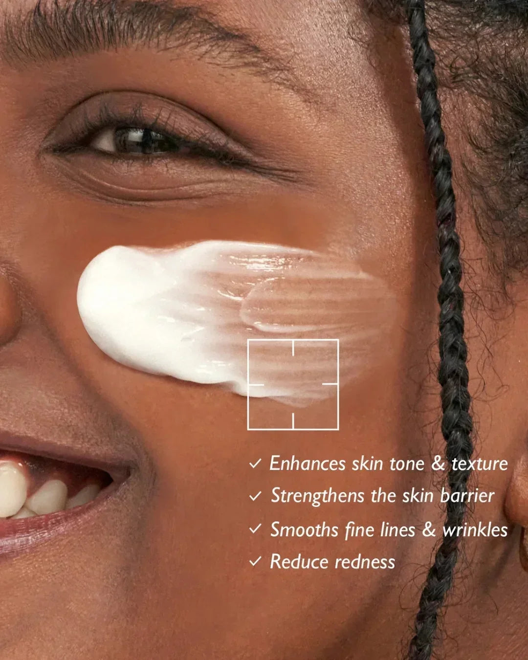 Close-up of smiling person with cream applied on cheek highlighting skin benefits like tone, texture, and redness