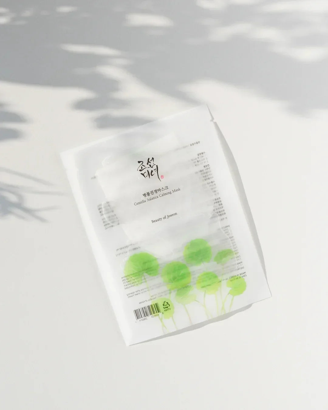 Centella Asiatica Calming Mask package on white surface with green leaves design and soft shadows