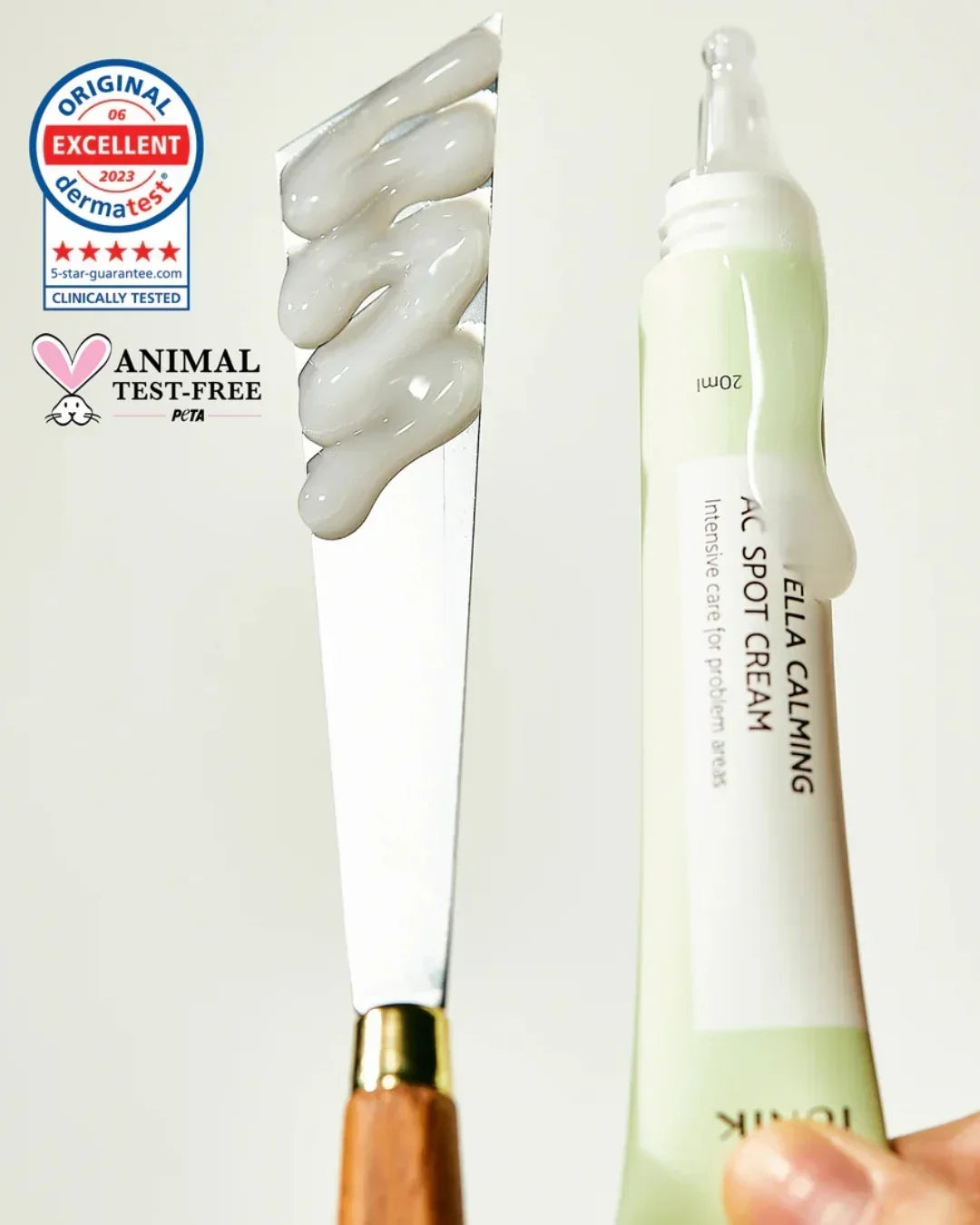 Tube of Centella Calming AC Spot Cream with cream on spatula and Dermatest animal test-free certifications